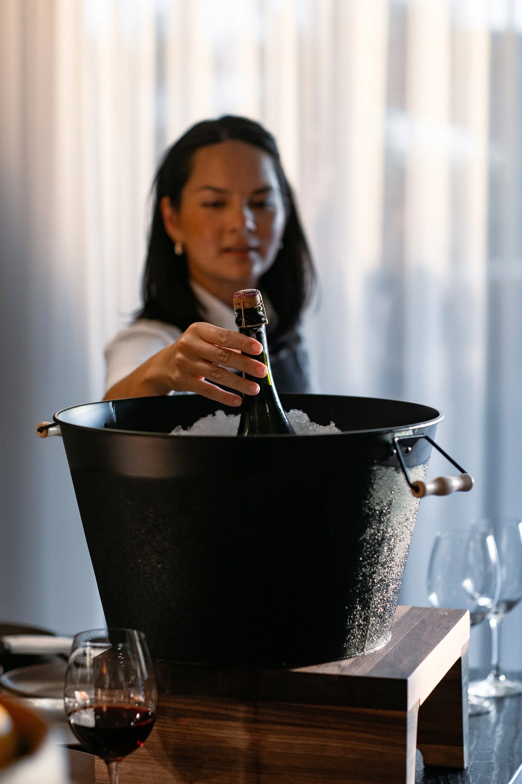 Chef Duyen Ha is holding her bottle of Champagne from BONDLE Wines