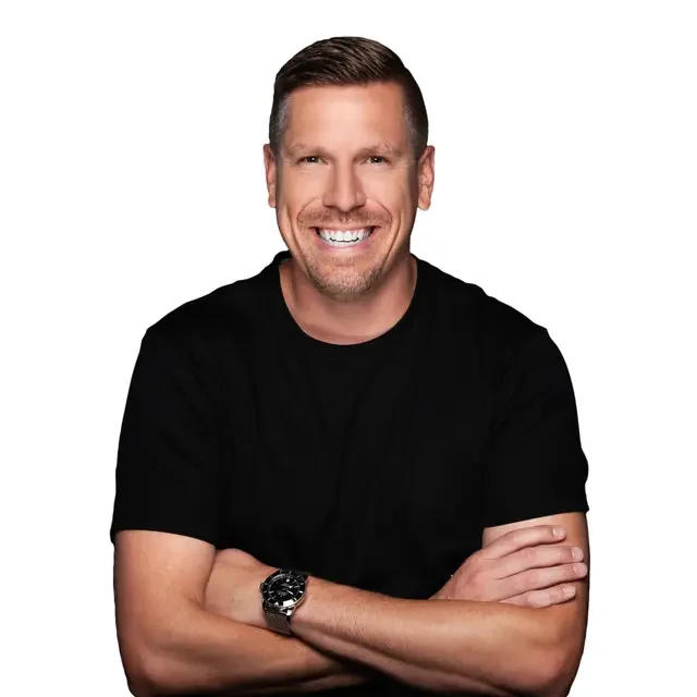 Andrew Cady - Mortgage Advisor, featured with short brown hair, wearing a black t-shirt, crossing his arms, against a plain white background.
