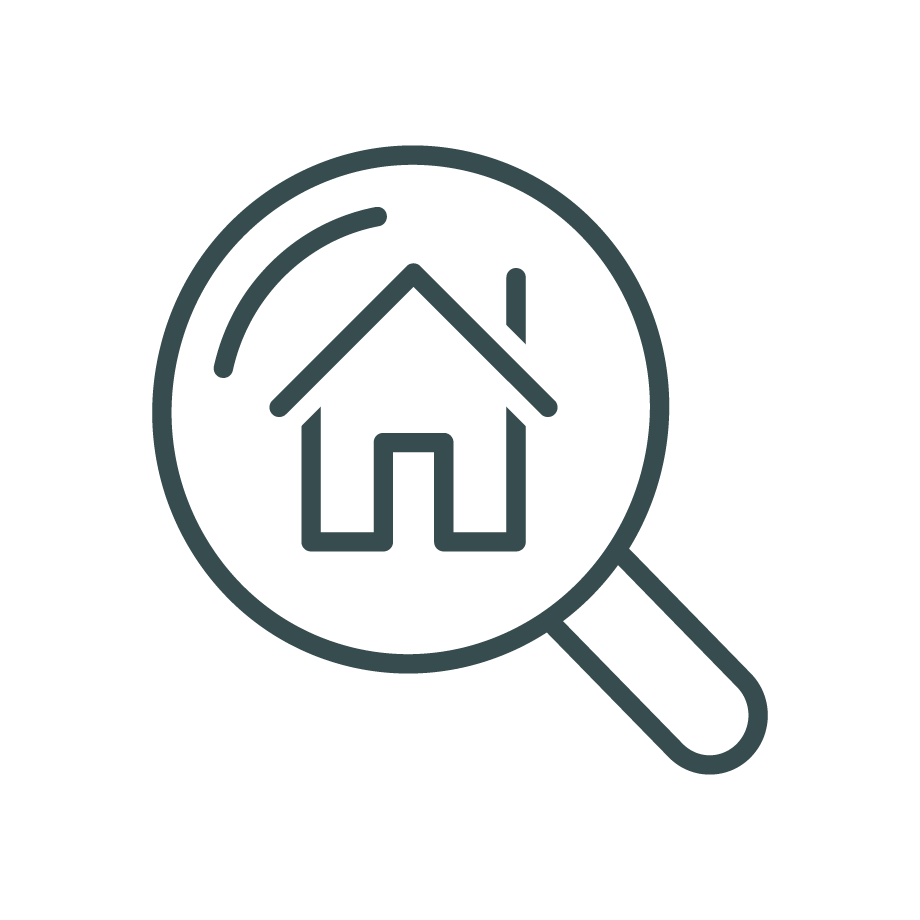 Magnifying glass focusing on a house icon, symbolizing real estate search or property examination.
