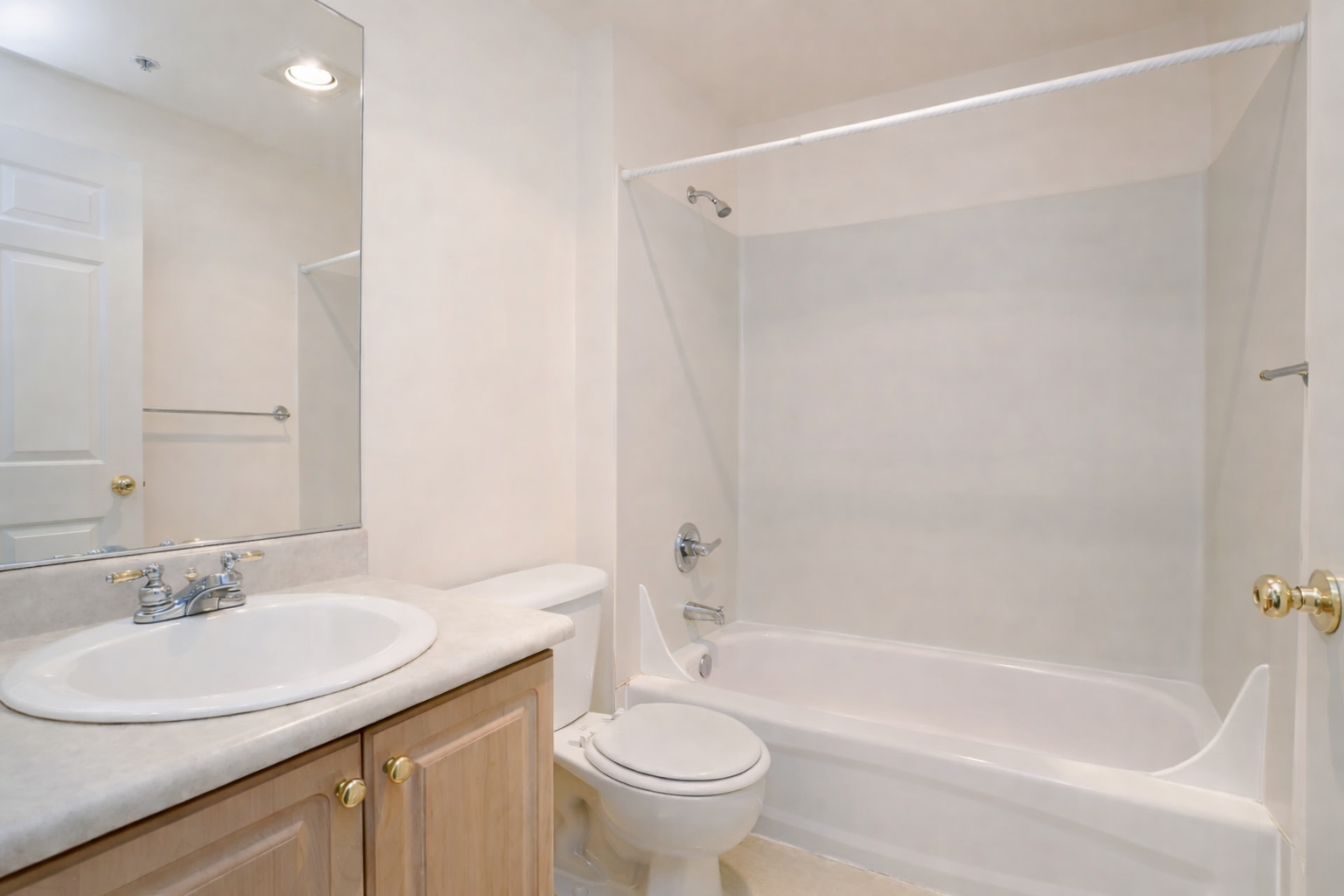 Full bathroom with bathtub and modern finishes at Ainsley Apartments in Seattle’s University District.