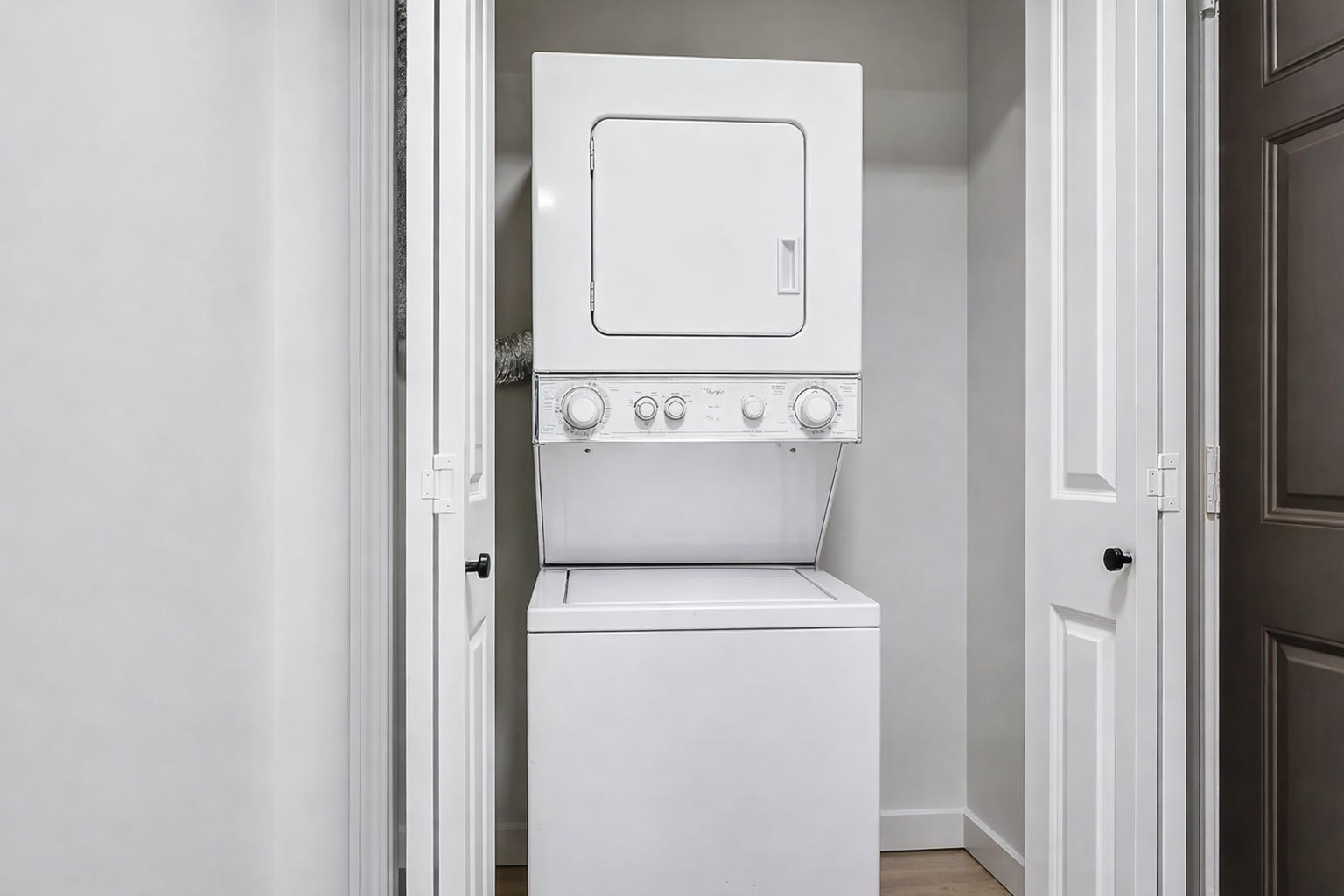 In-unit stacked washer and dryer at Ainsley Apartments in Seattle’s University District.