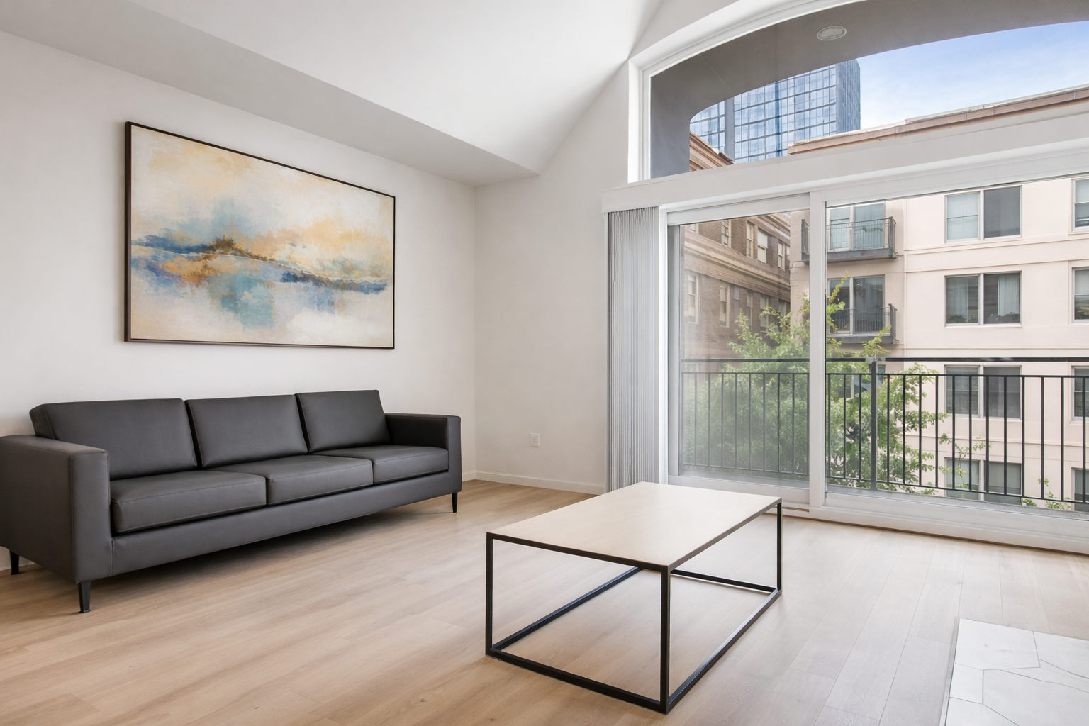 Bright living room with balcony access at Ainsley Apartments near the University of Washington.