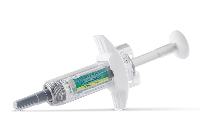 A medical syringe with a green and yellow label, and a gray needle cap, lying horizontally on a transparent background.