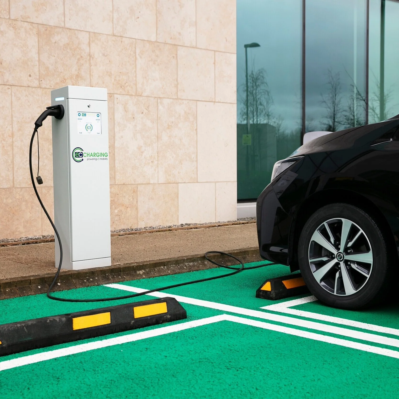 Car being charged with an EC Charging station in a car park