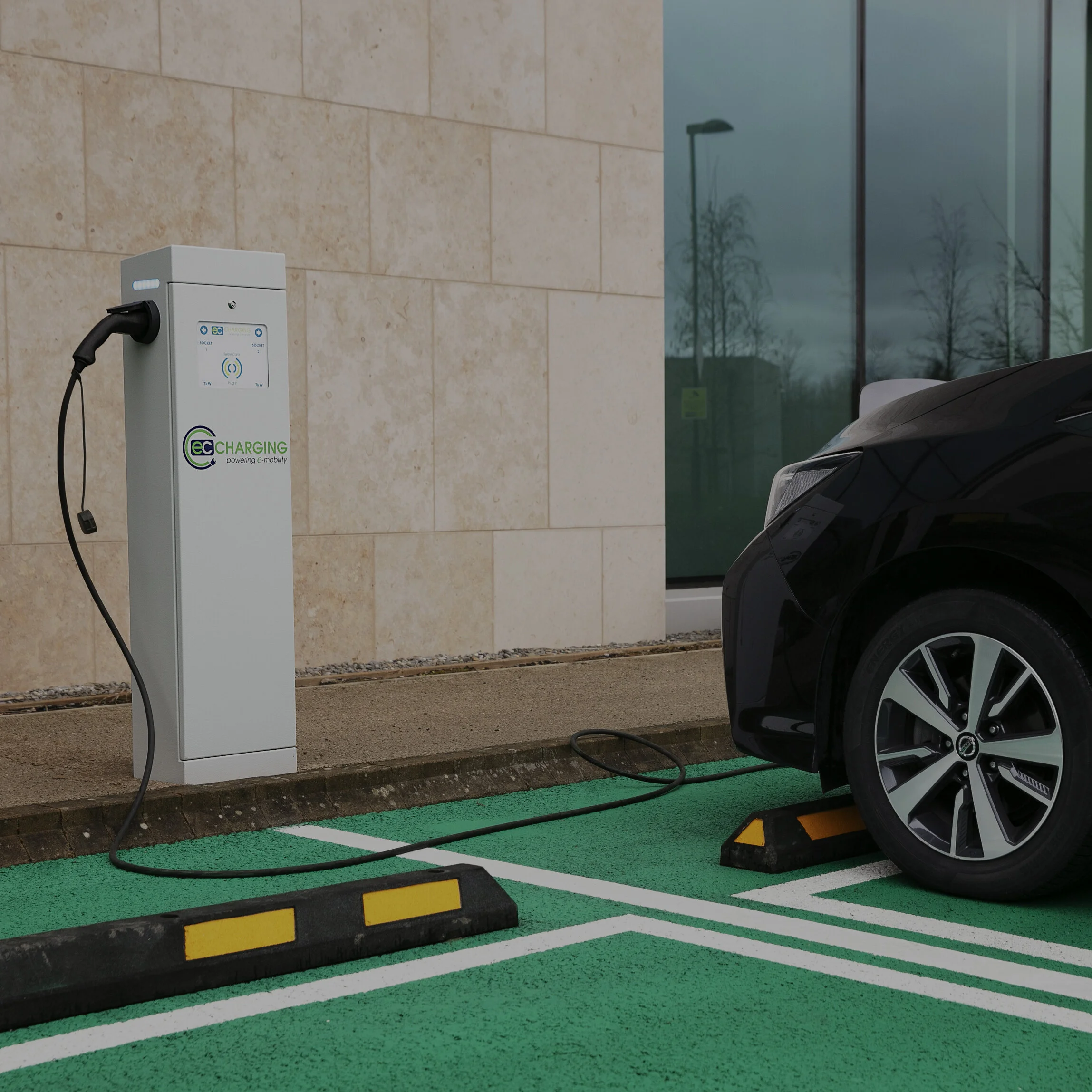 Car being charged with an EC Charging station in a car park