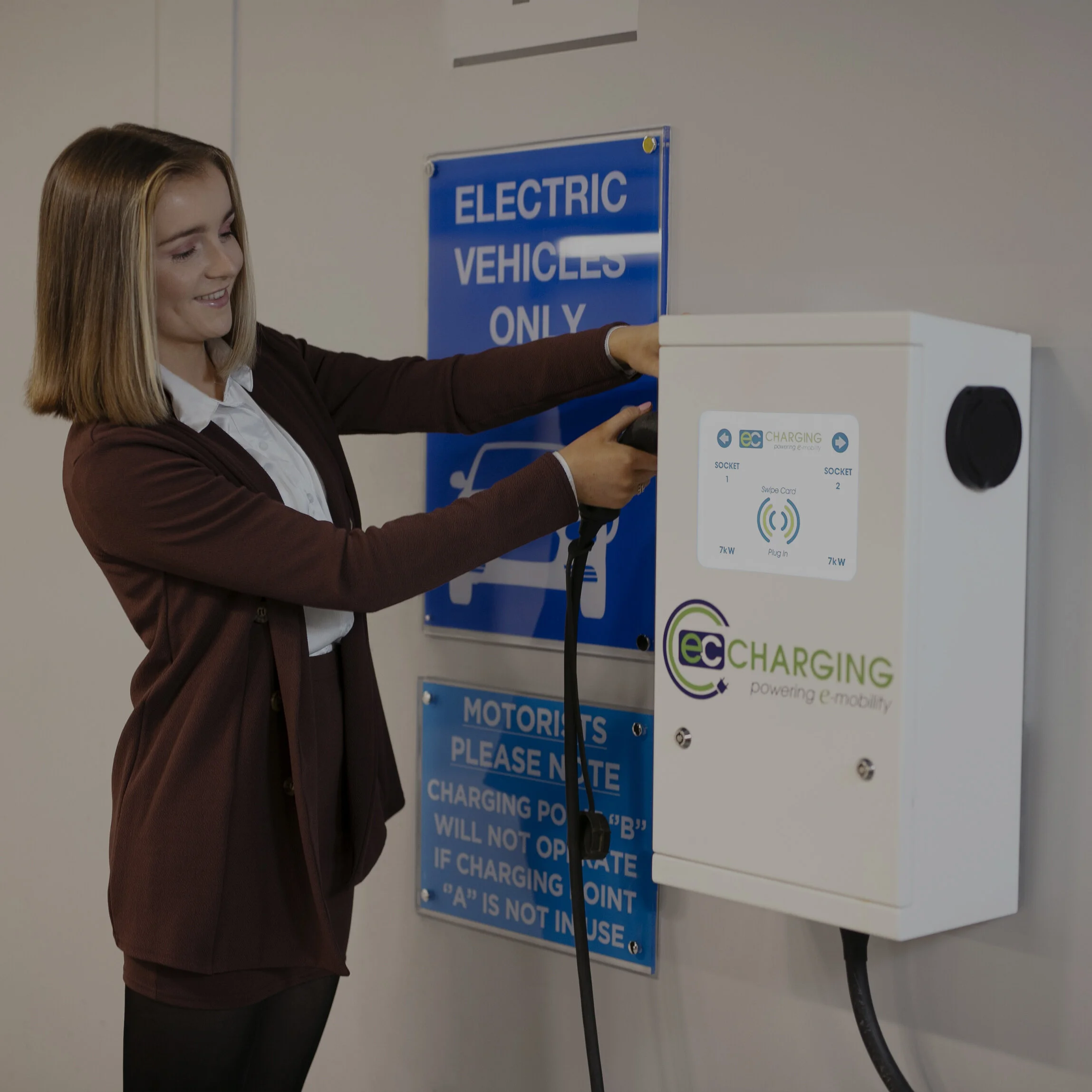 Someone using a EC Charging wall unit