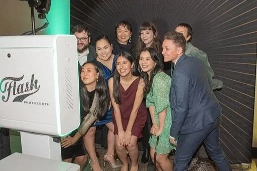 Group of people taking a photobooth photo together