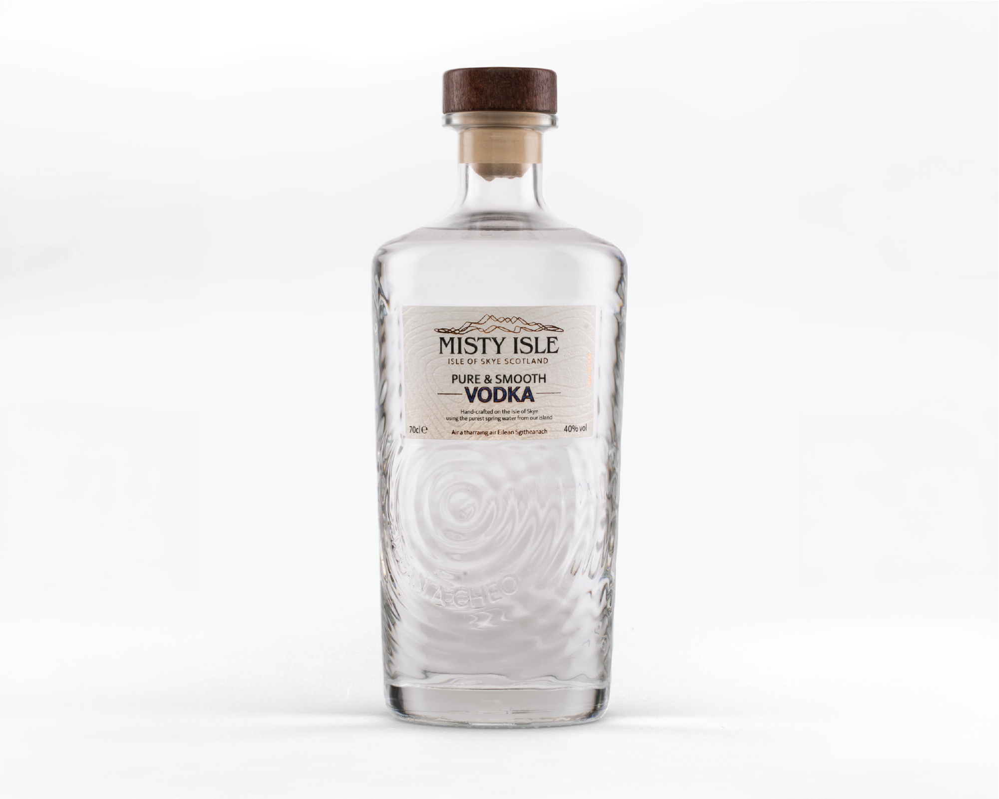 A clear glass bottle of Misty Isle pure and smooth vodka with a wooden cap, label visible, against a white background.