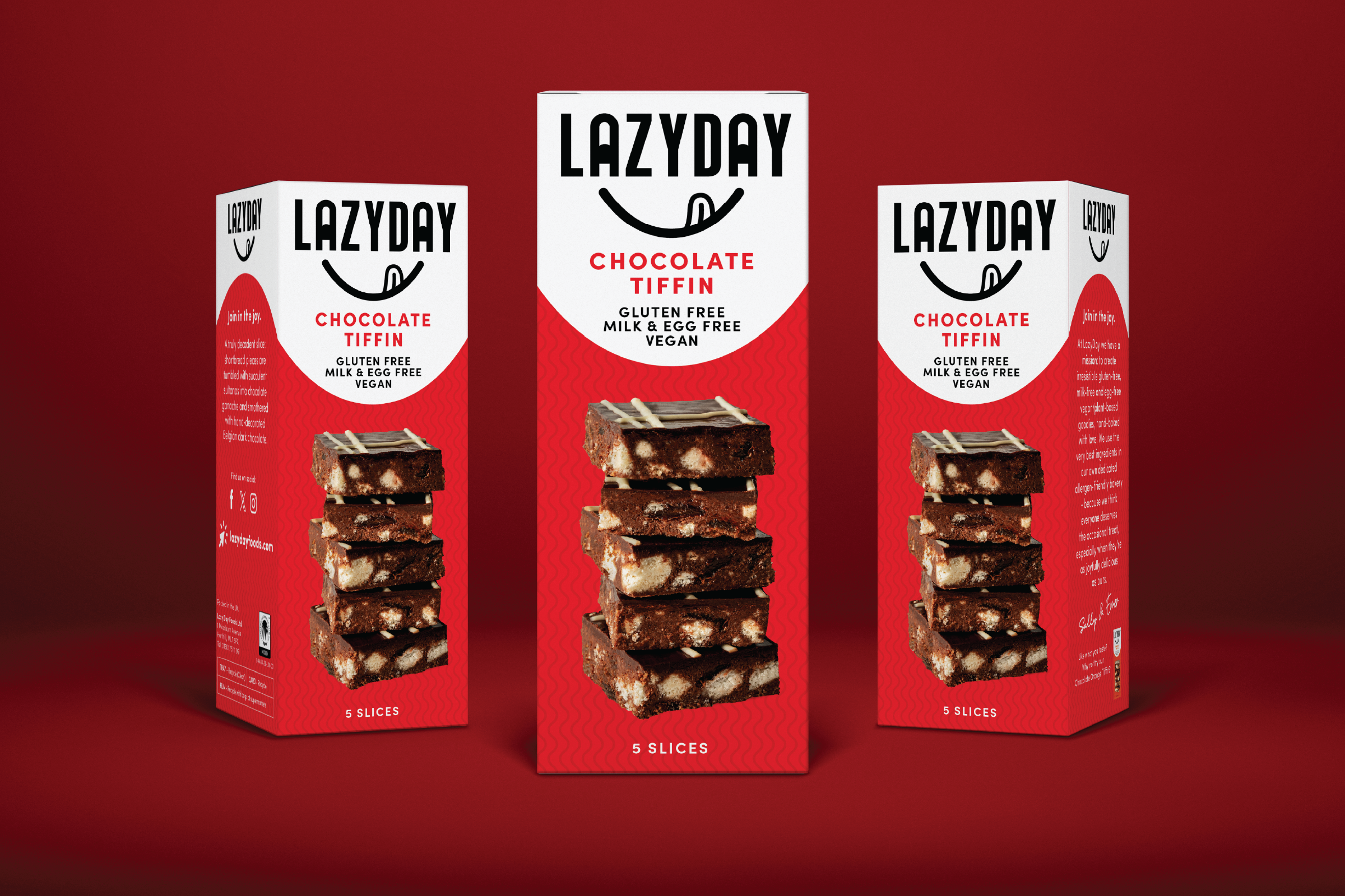 Three boxes of Lazyday Chocolate Tiffin snack stacked on a red background, featuring images of chocolate squares with white filling and the brand logo.