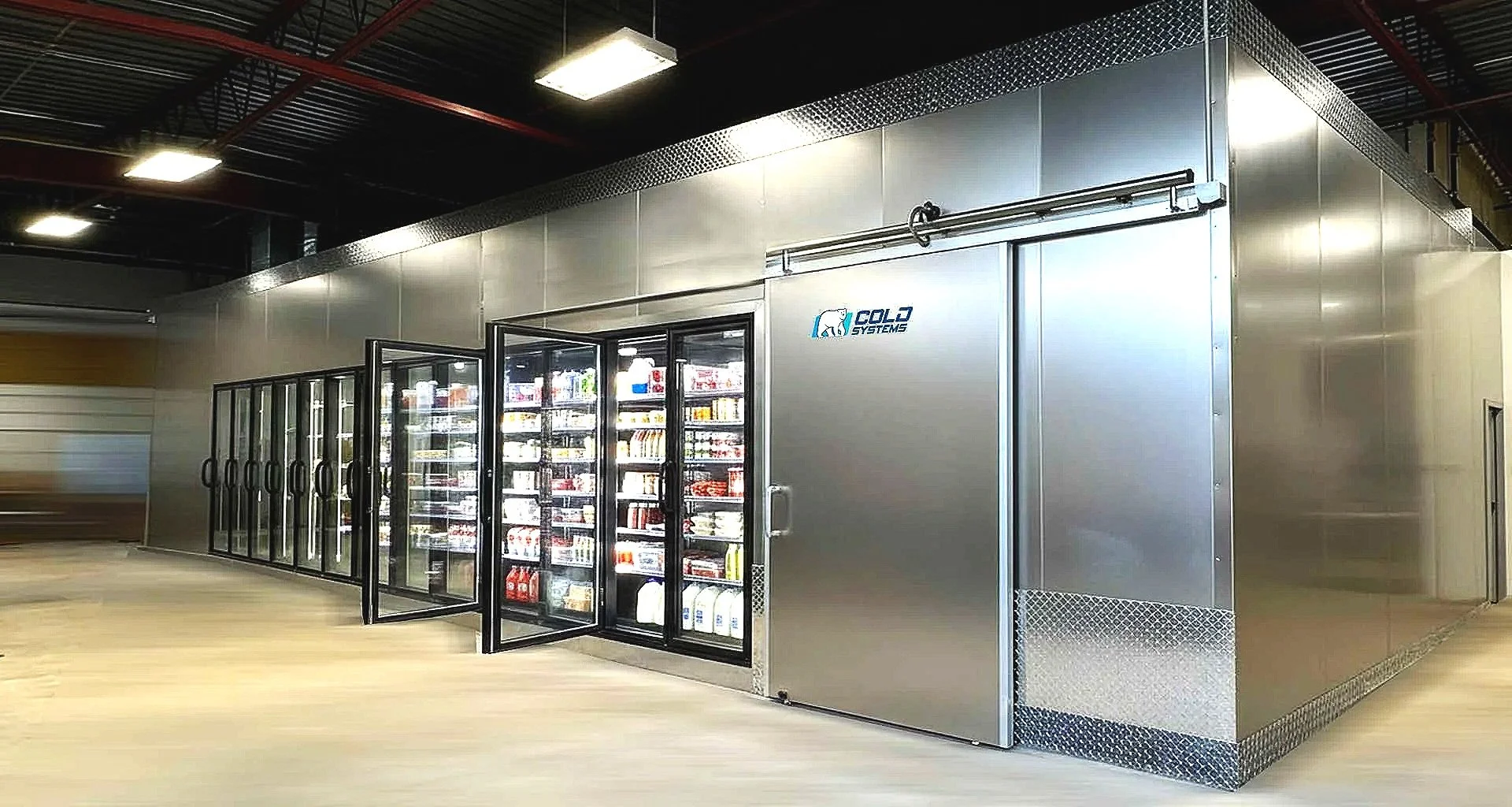 Refrigeration unit in a modern commercial or industrial setting with glass doors displaying various items inside, branded with Cold Systems logo.