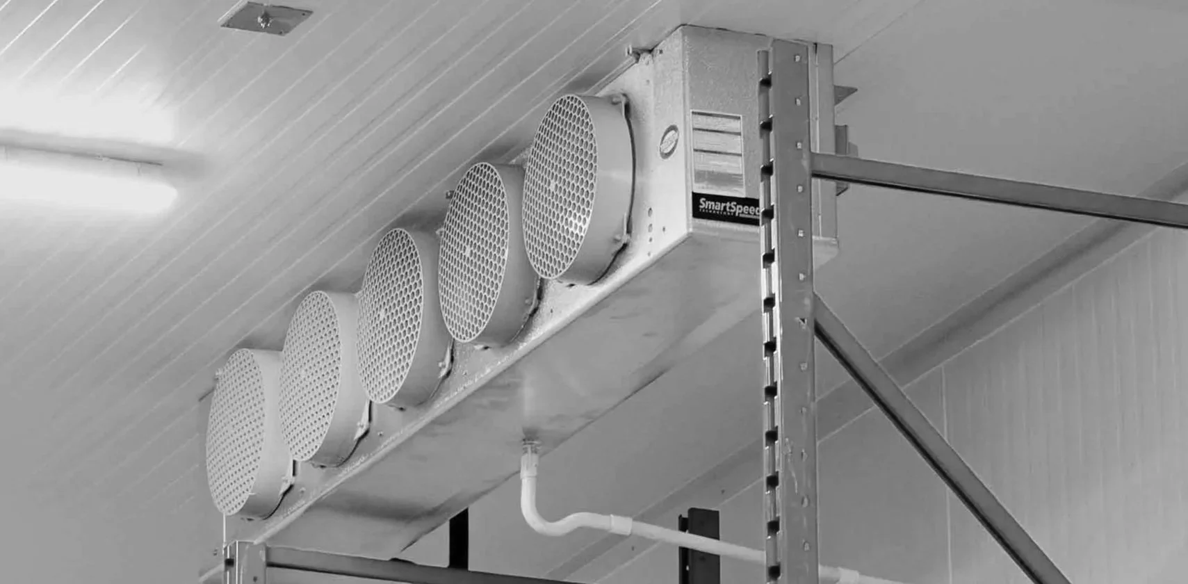 Industrial heating system with four fans mounted on a metal frame, connected with electrical wiring, installed on a ceiling.