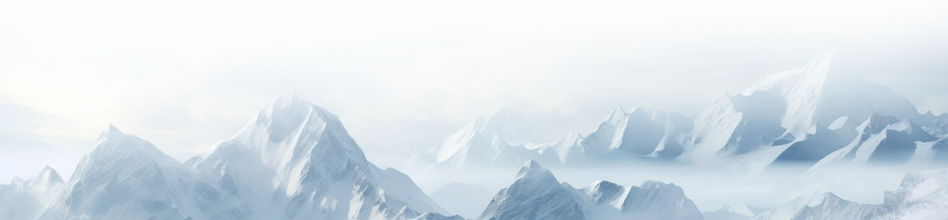 Snow-covered mountain peaks under a partly cloudy sky with a rainbow-like optical phenomenon.