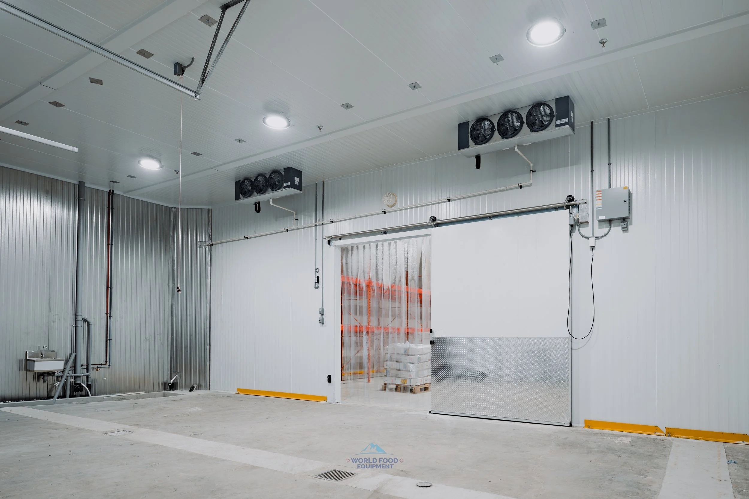 Custom-built industrial walk-in cooler warehouse with reinforced insulated flooring and high-R-value panels for long-term frozen inventory.