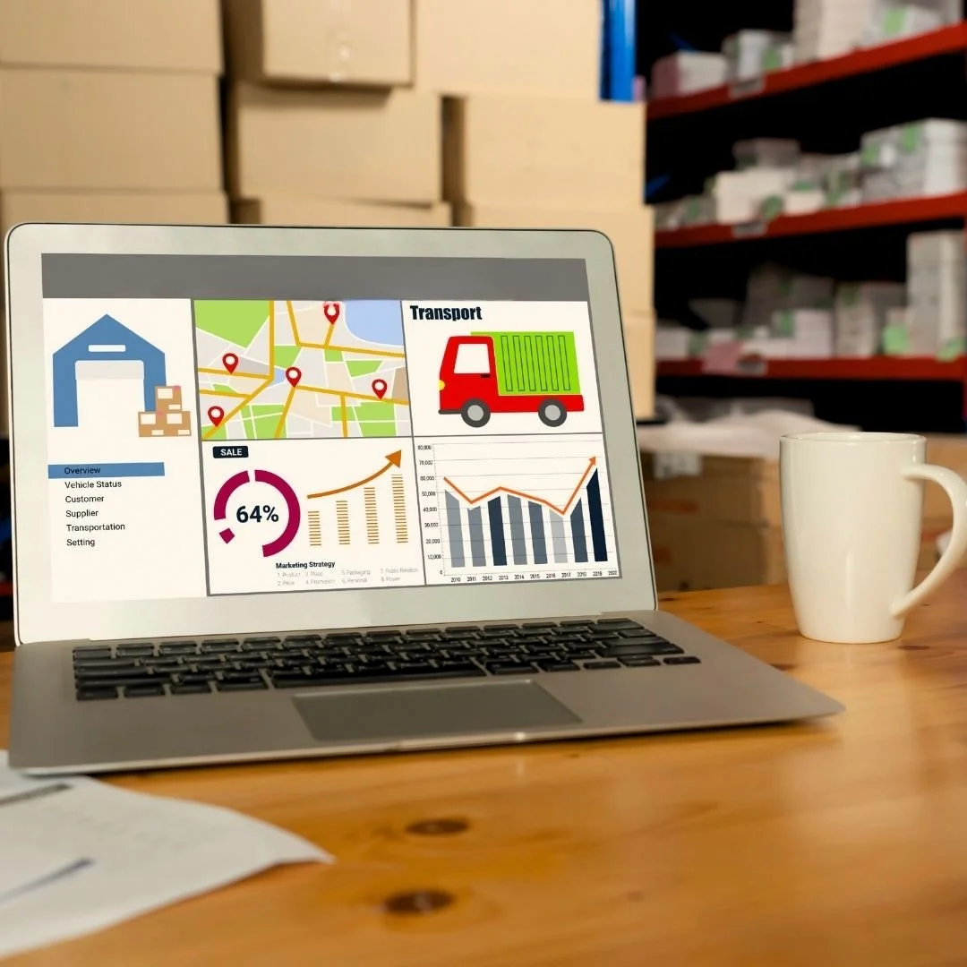 Warehouse shelf with boxes and packages in the background and a laptop in the foreground showing high sales and tracked logistics, highlighting efficient inventory management and business growth solutions.