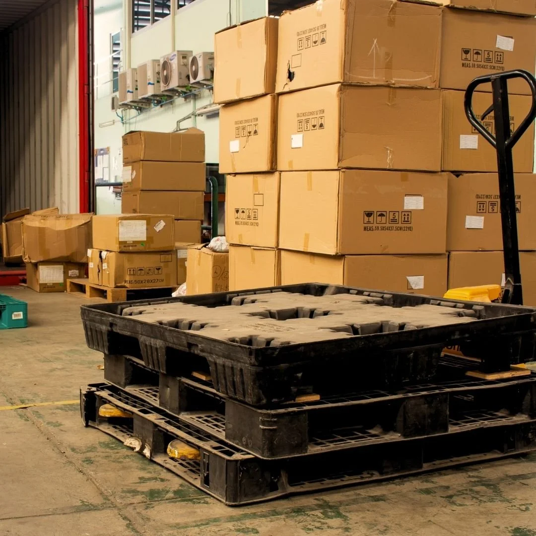 Warehouse exterior with boxes and packages being loaded for shipping, showcasing efficient logistics, timely fulfillment, and reliable supply chain solutions for businesses and brands.