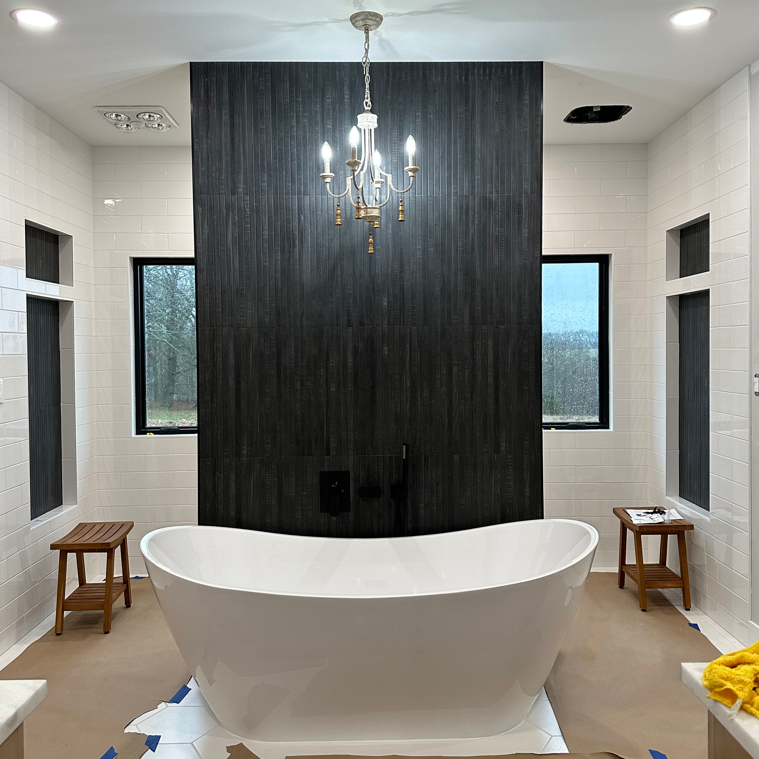 In Progress modern bathroom with a freestanding bathtub, Commercial Bathroom cleaning by White Knight Janitorial. 