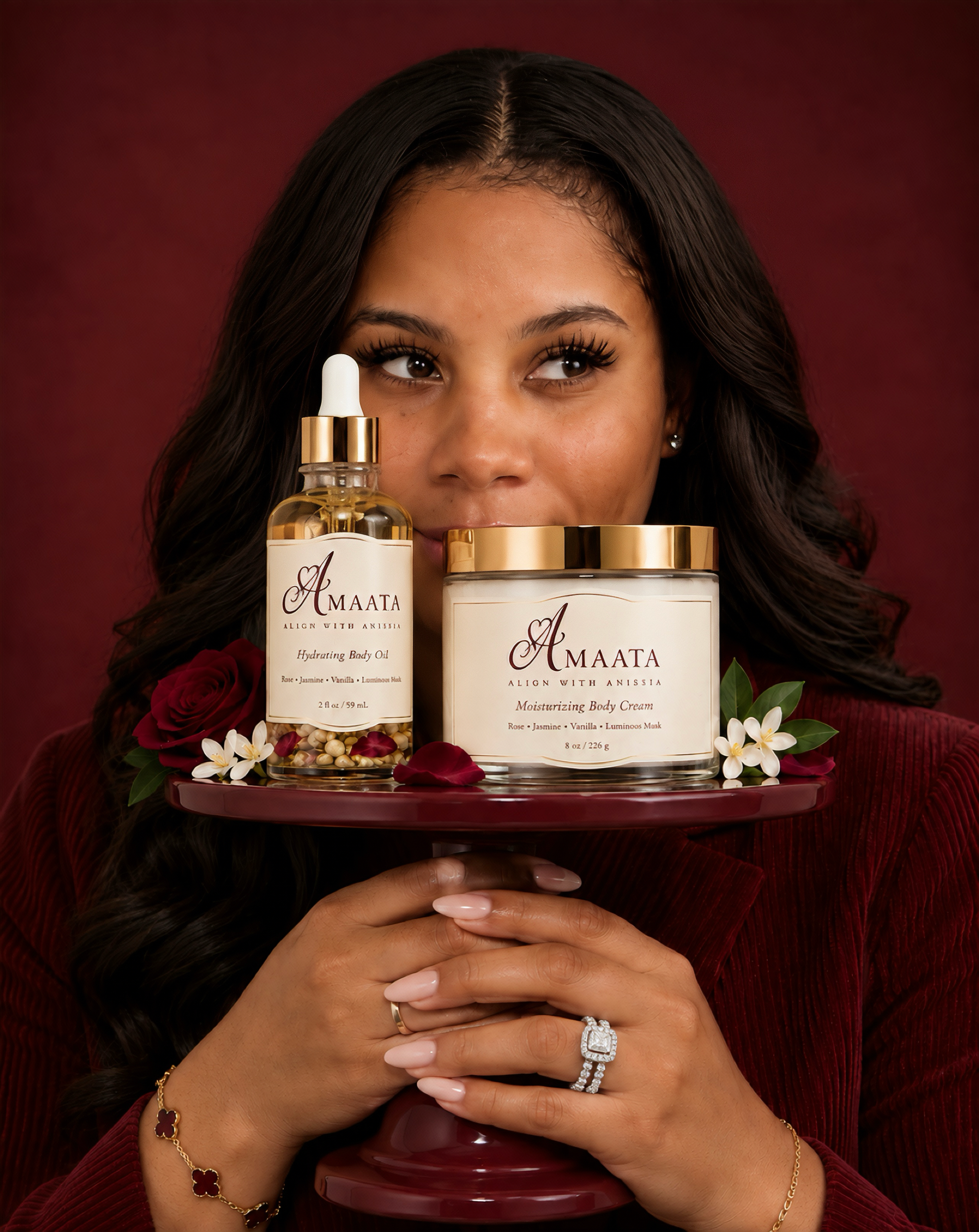 Anissia Harper-Jones, founder of Align With Anissia, holding AMAATA Hydrating Body Oil and Moisturizing Body Cream.”