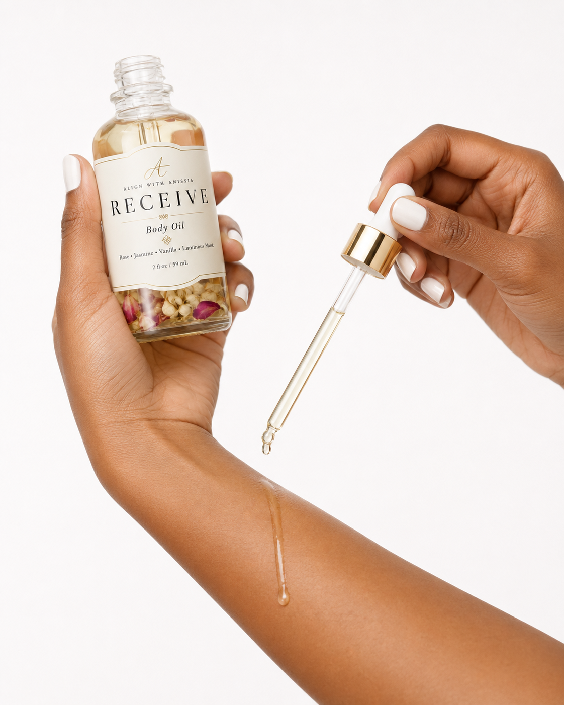 Receive Body Oil being applied to a medium brown arm with a glass dropper.