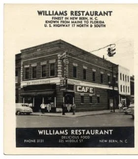 Historical black-and-white photograph of Williams Restaurant, a two-story brick building with a cafe sign, located on a street corner in New Bern, North Carolina, with pedestrians and vintage cars visible.