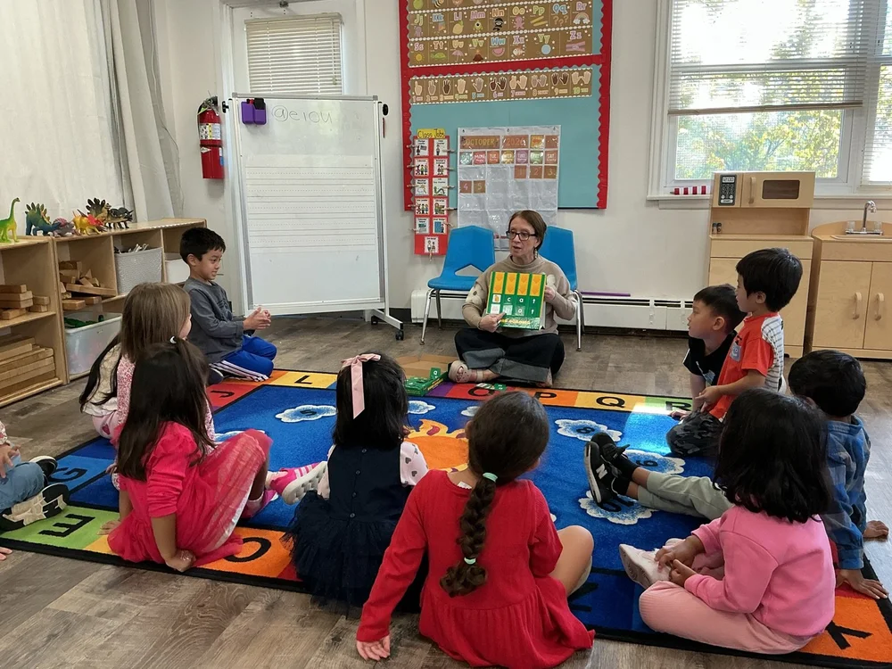 A teacher reading to children at circle time