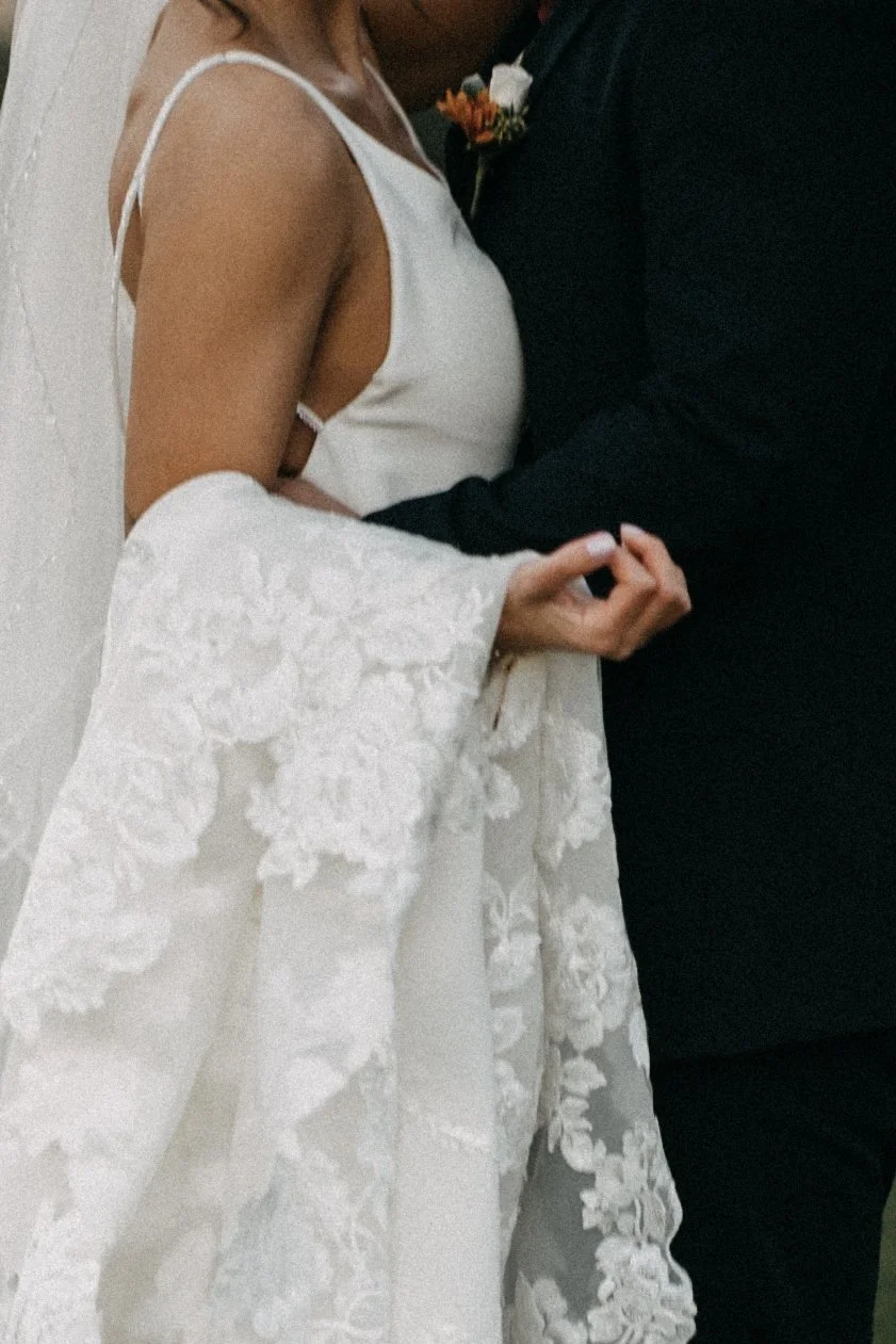 A bride and groom holding hands during a wedding ceremony.