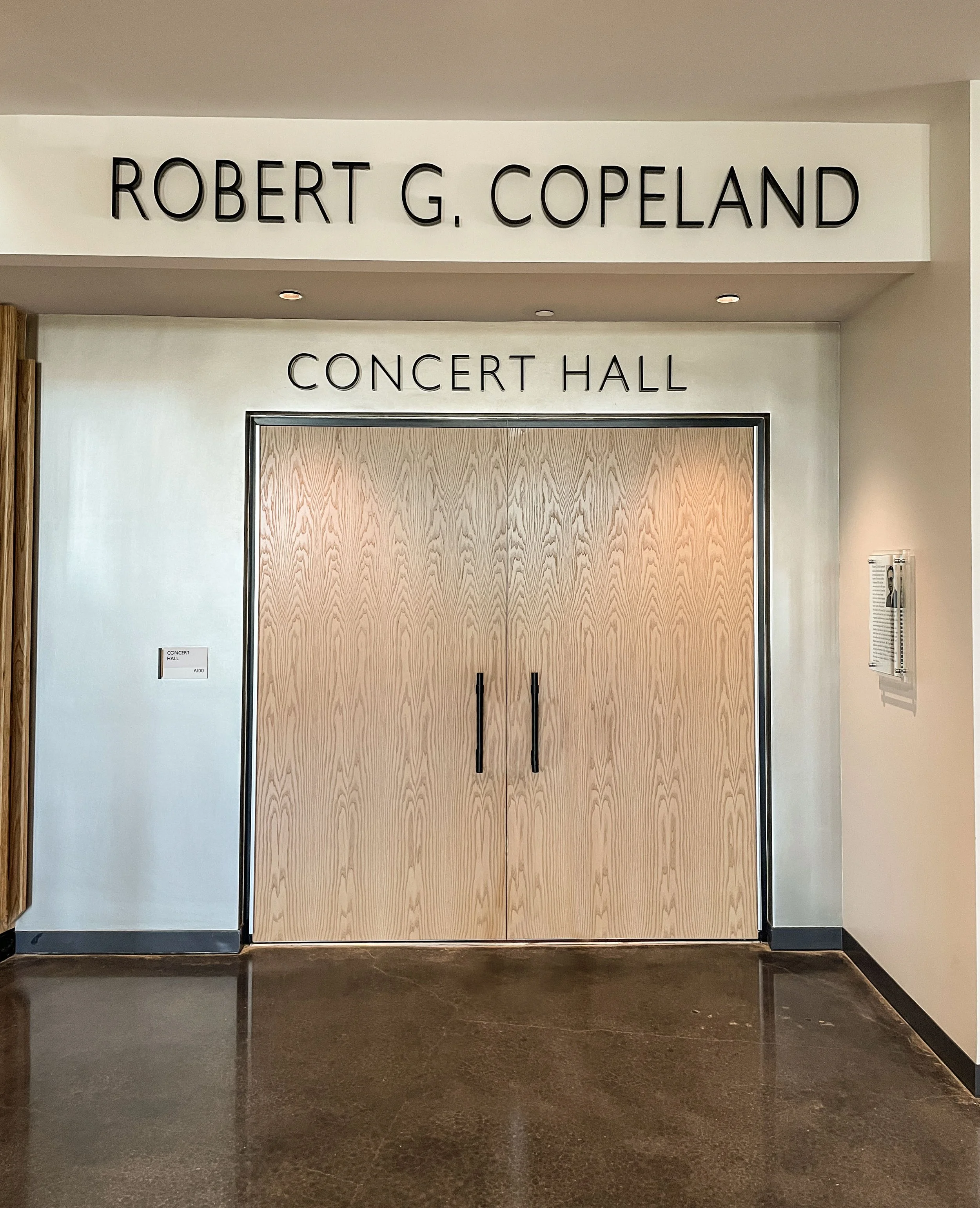 Glass doors labeled 'Concert Hall' beneath a wall sign reading 'Robert G. Copeland'.