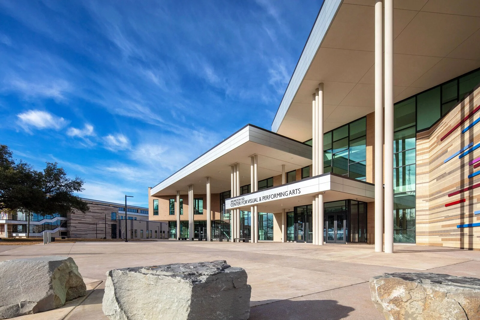 Exterior view of the Arlington ISD Center for Visual & Performing Arts building with a clear blue sky overhead.
