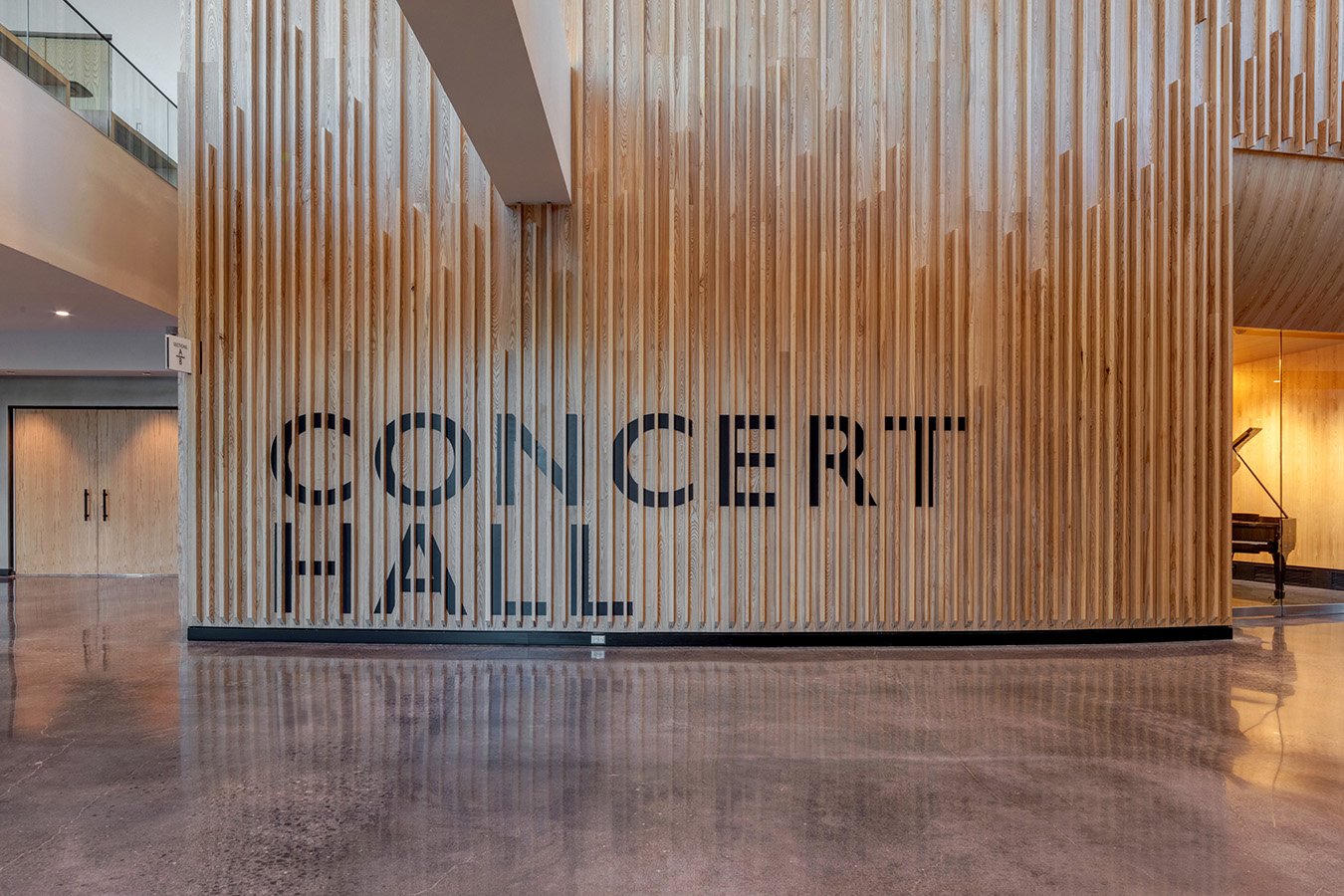 Interior view of the Microsoft Conference Hall with wooden wall panels and large black letters spelling "CONFERENCE HALL".