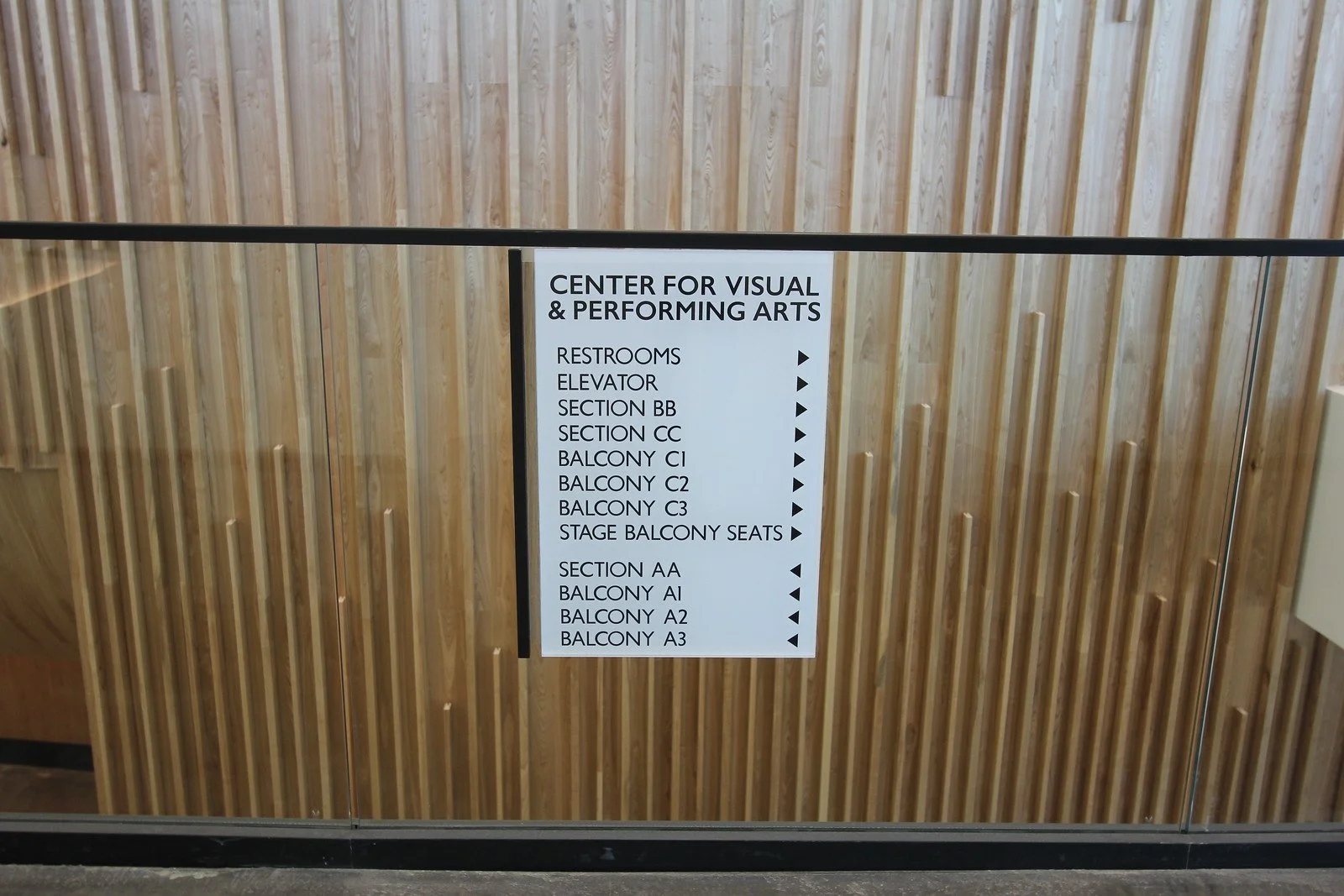 Sign for the Center for Visual & Performing Arts with directions to restrooms, elevator, balcony sections, stage balcony seats, and balcony sections.