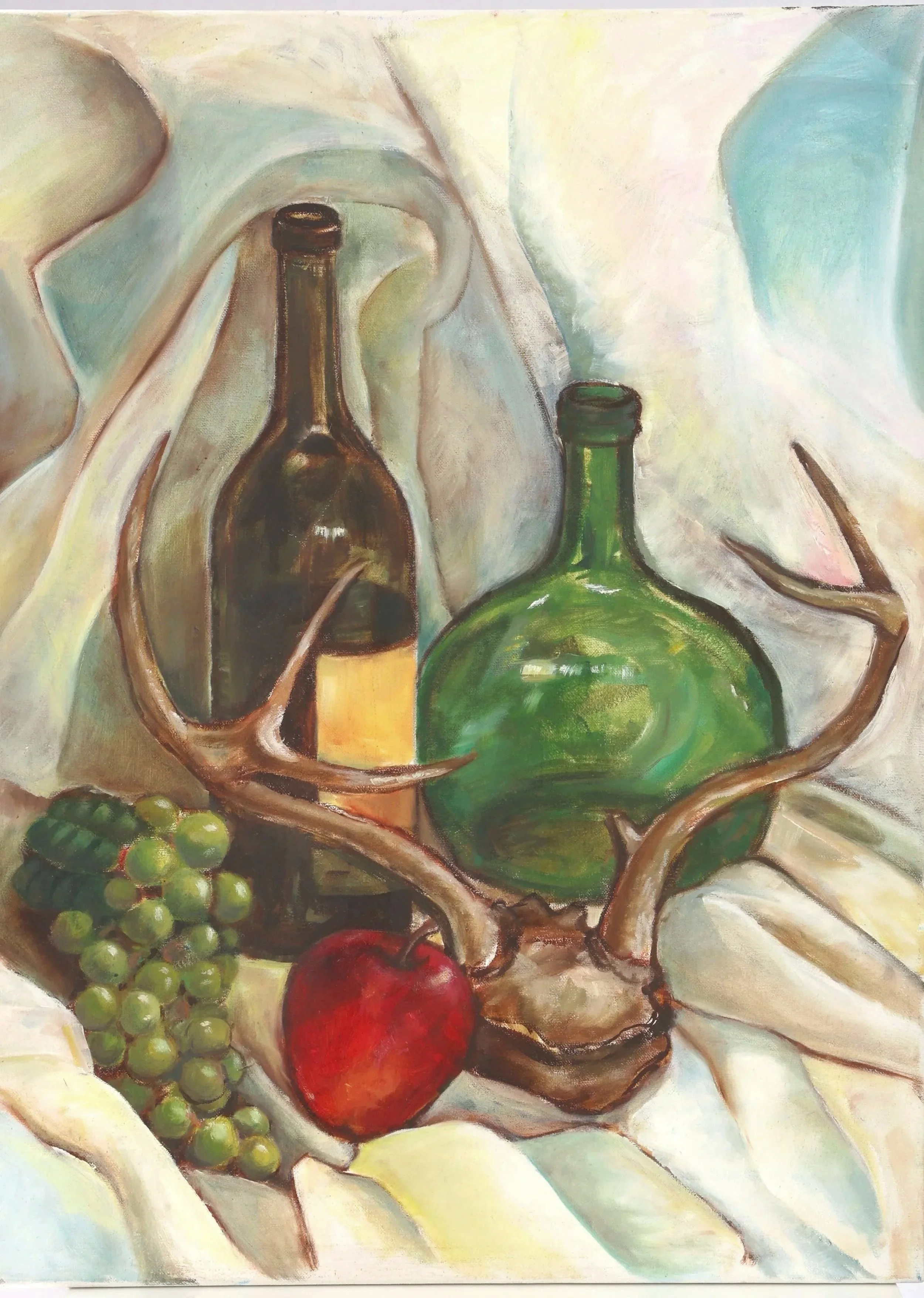 A still life painting featuring two bottles, a bunch of green grapes, a red apple, a pair of antlers, and a draped cloth in the background.