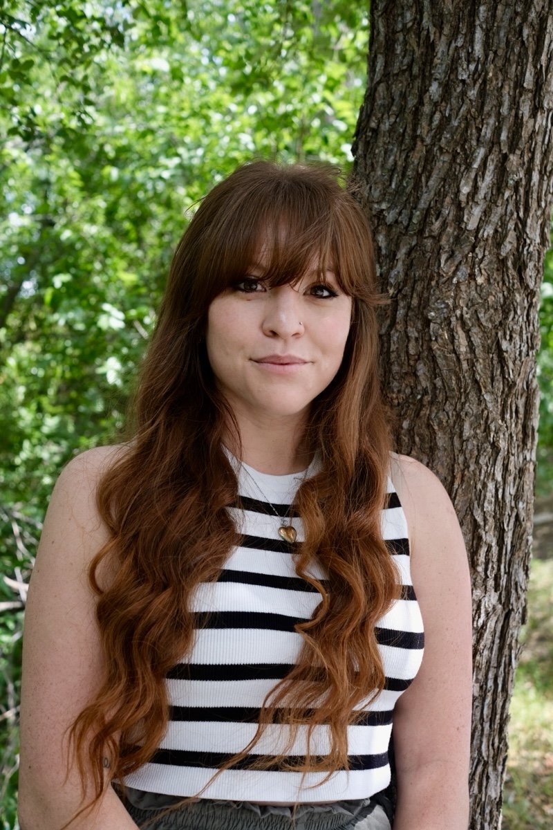 Young adult woman outdoors, representing self-exploration and therapy clients