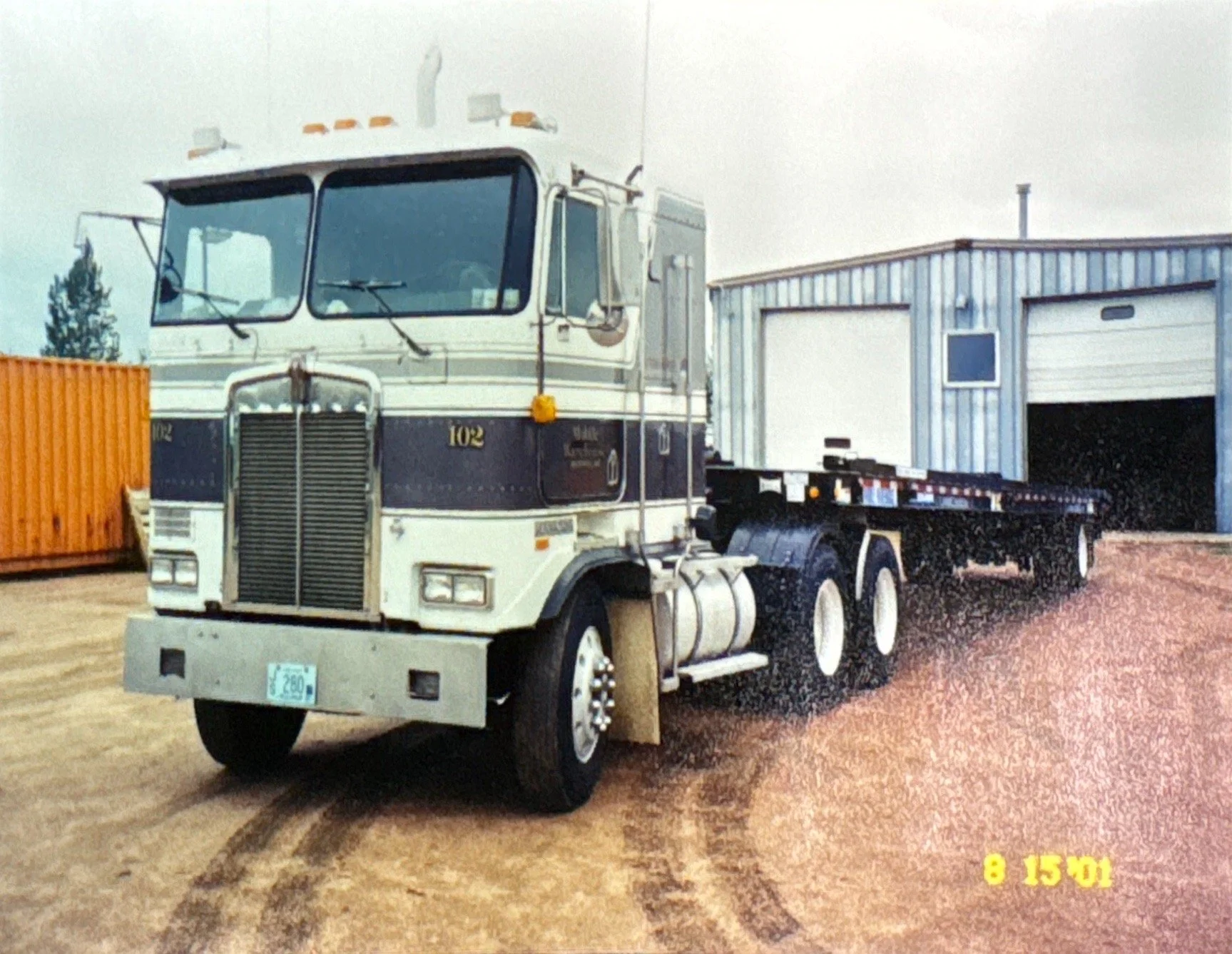 Kenworth cabover with Shipping Container tilt bed trailer