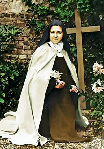 St. Thérèse kneeling in the garden with a lily Holy Card