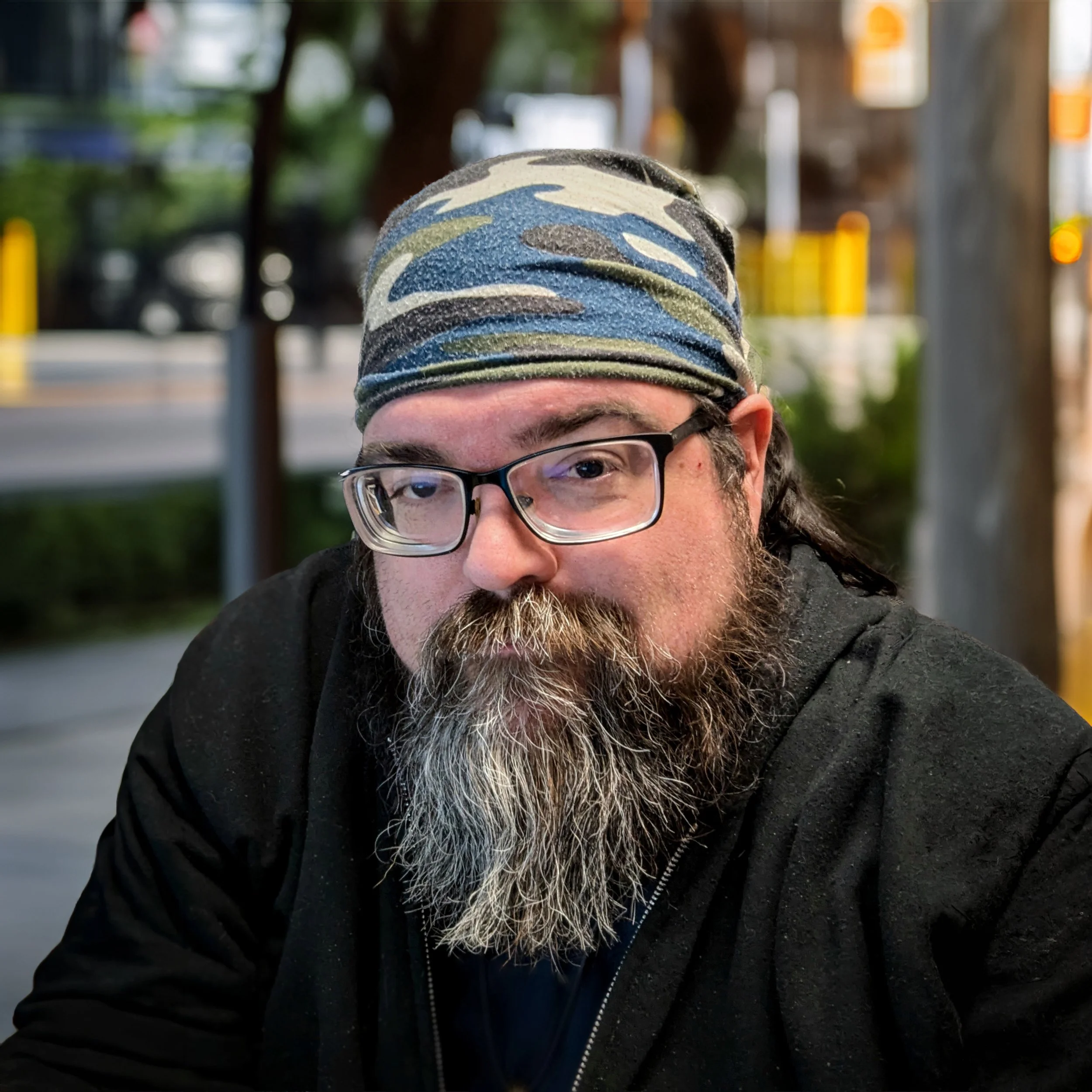 a headshot of jeremy thompson in a park