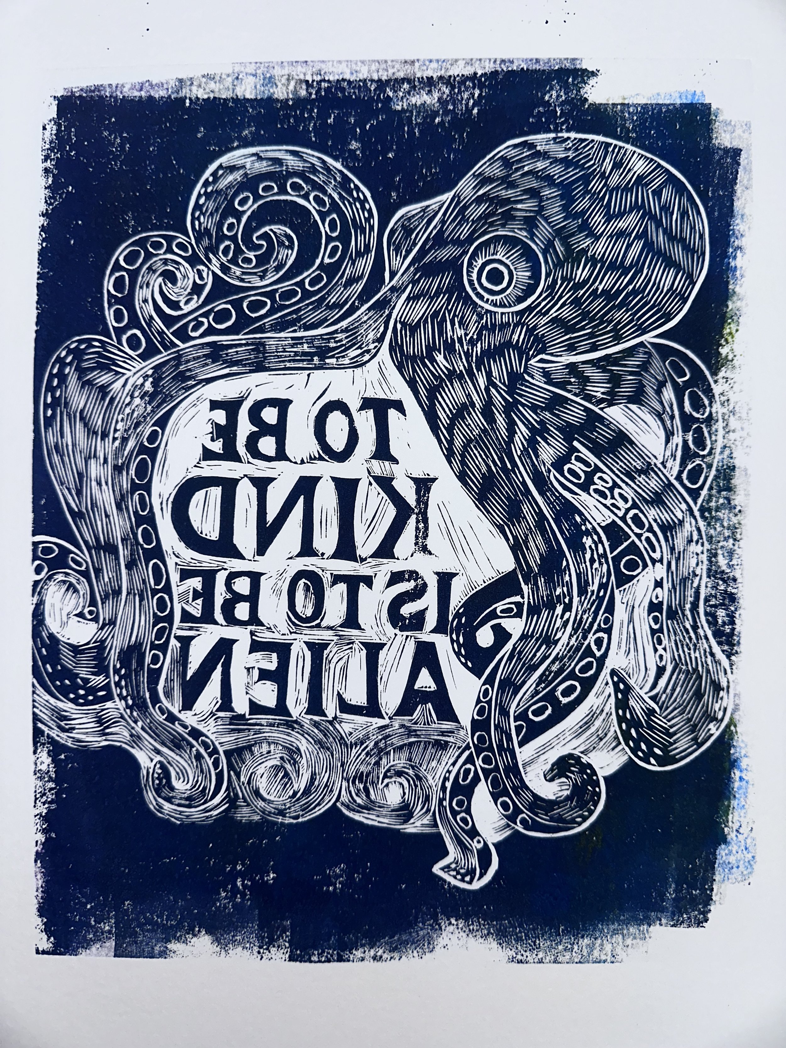 a blue and white piece of art depicting an octopus surrounding the backward words "to be kind is to be alien"