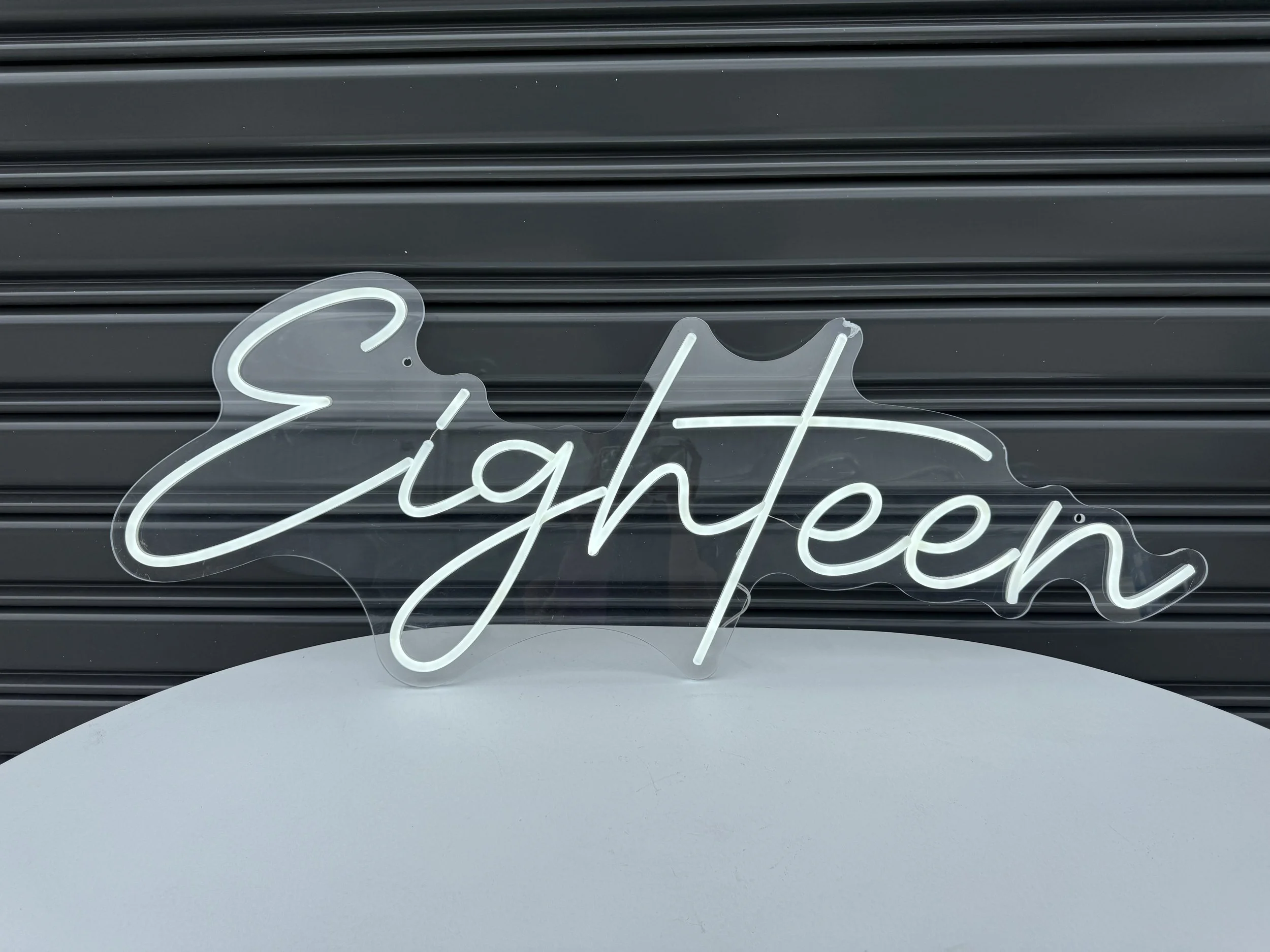 Neon_sign_Eighteen_(lit_up).jpg
