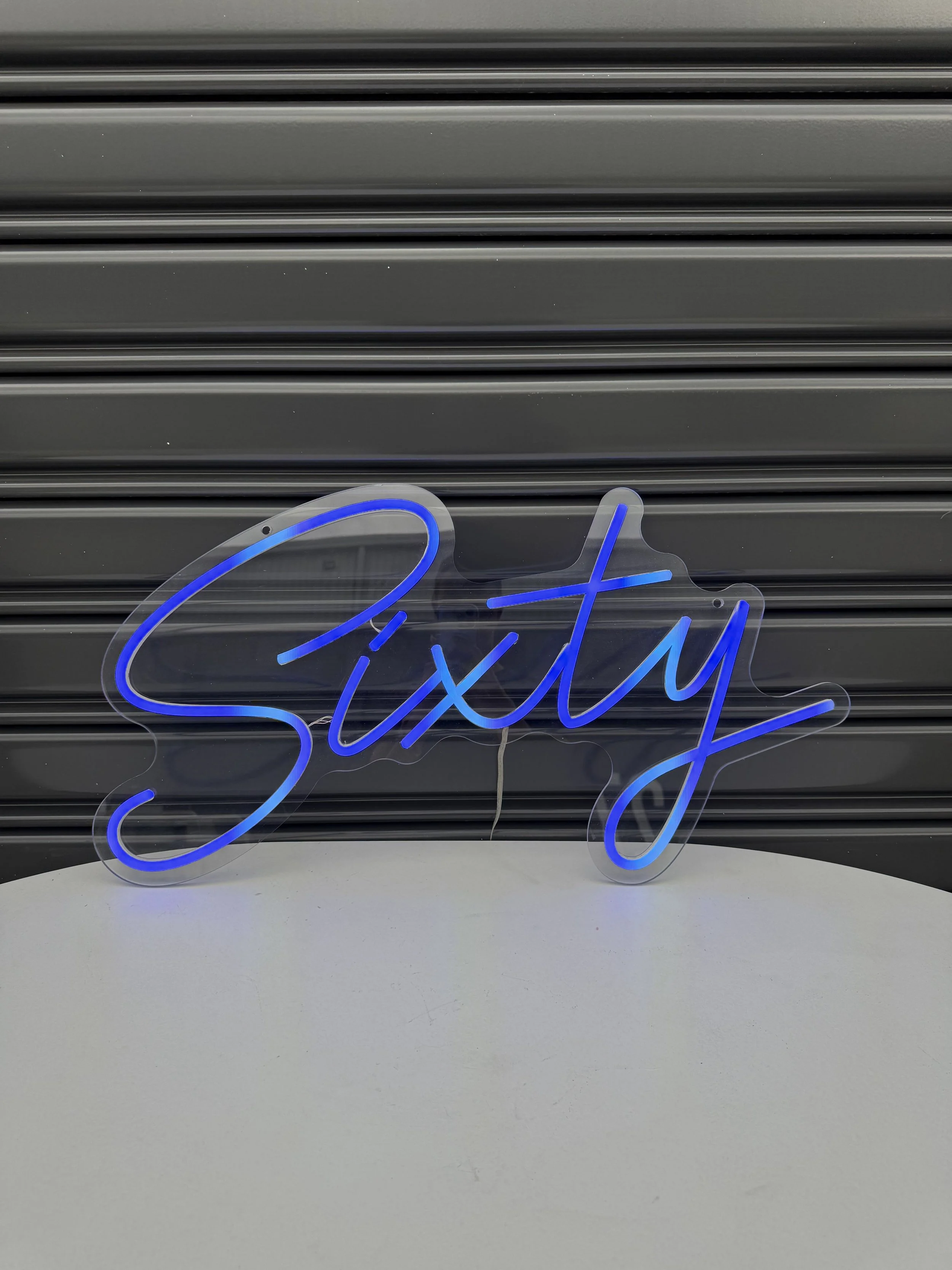 Neon_sign_Sixty_(lit_up).jpg
