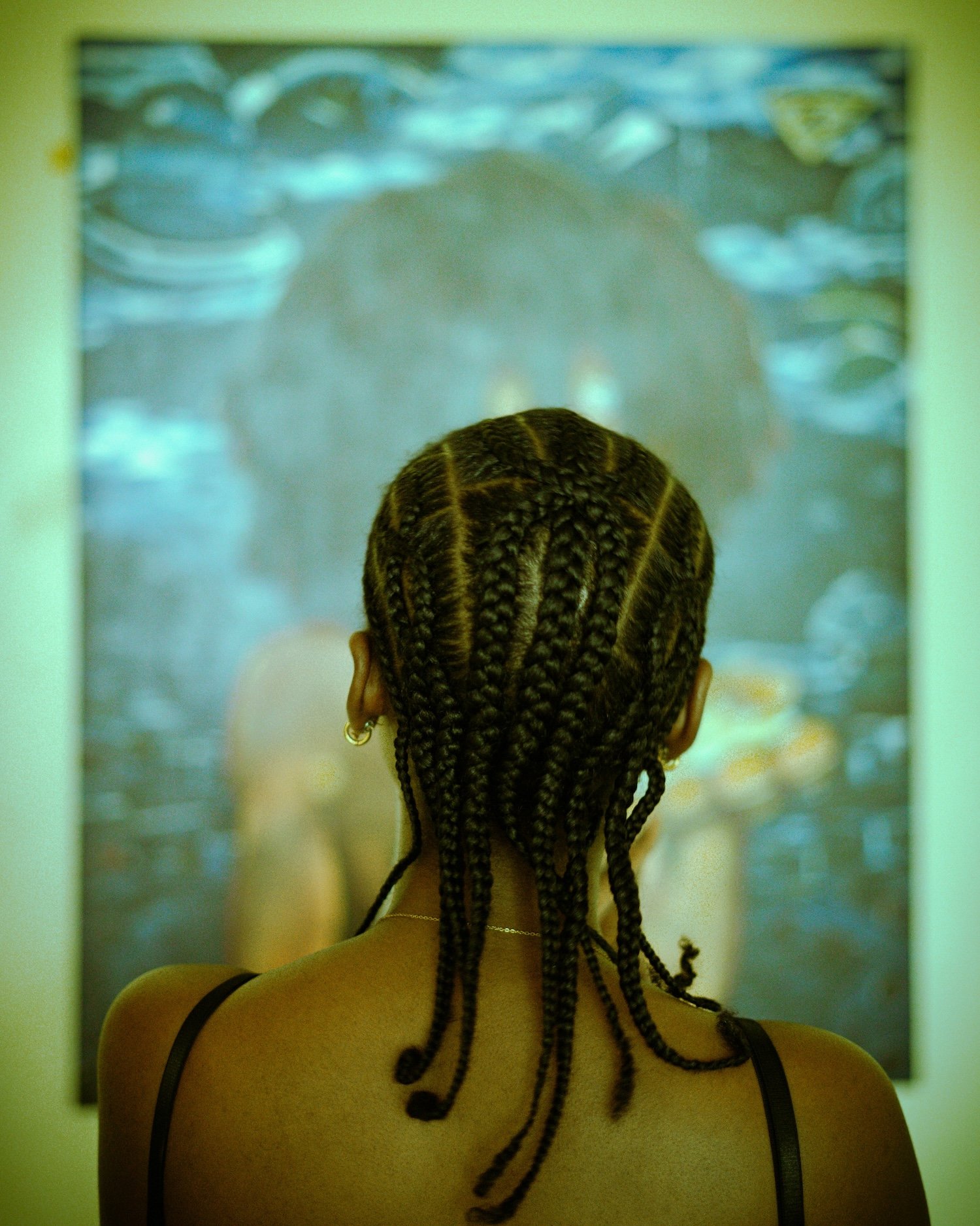 Women staring at blurred painting