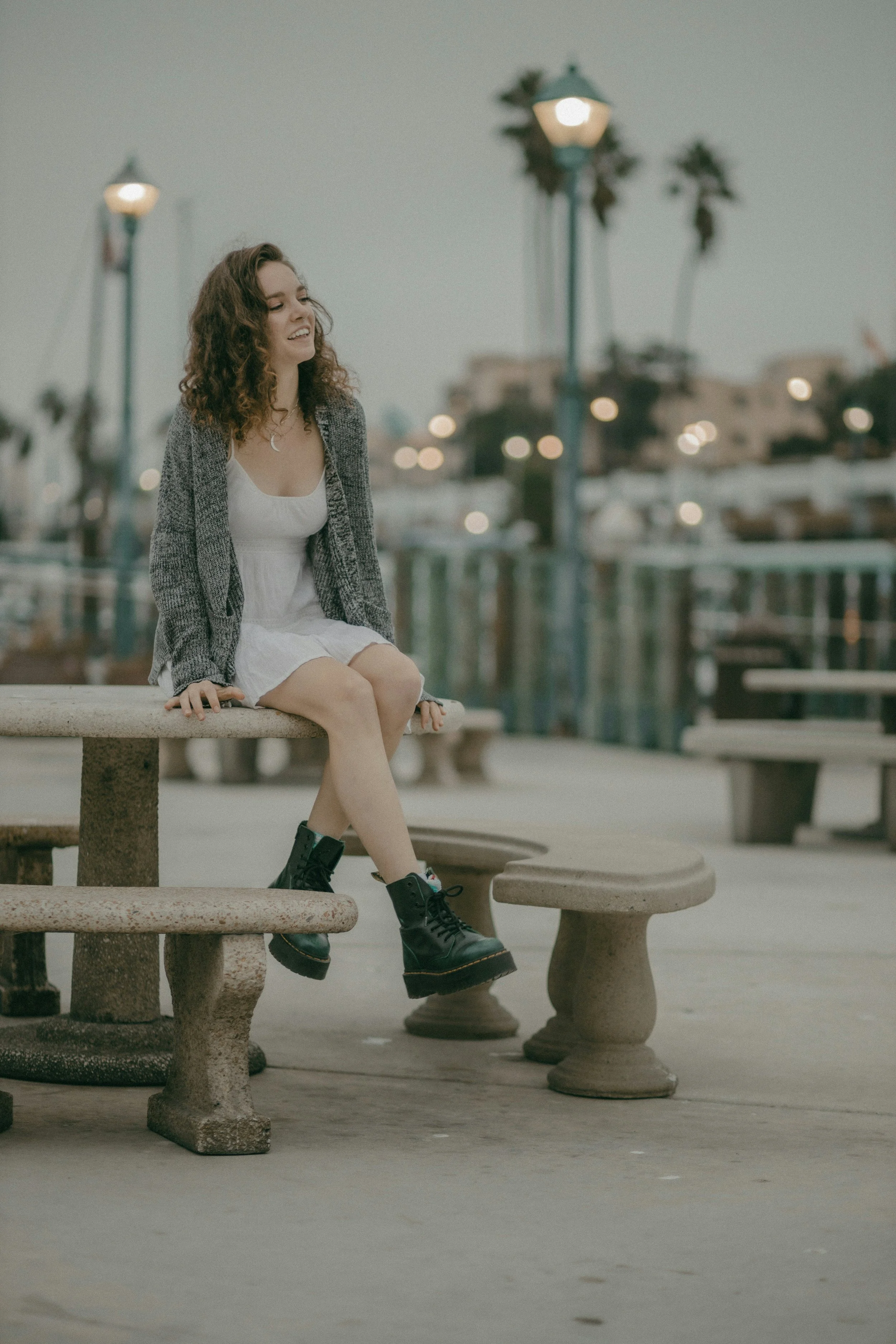 Woman smiling genuinely alone outdoors, reconnecting with her authentic self