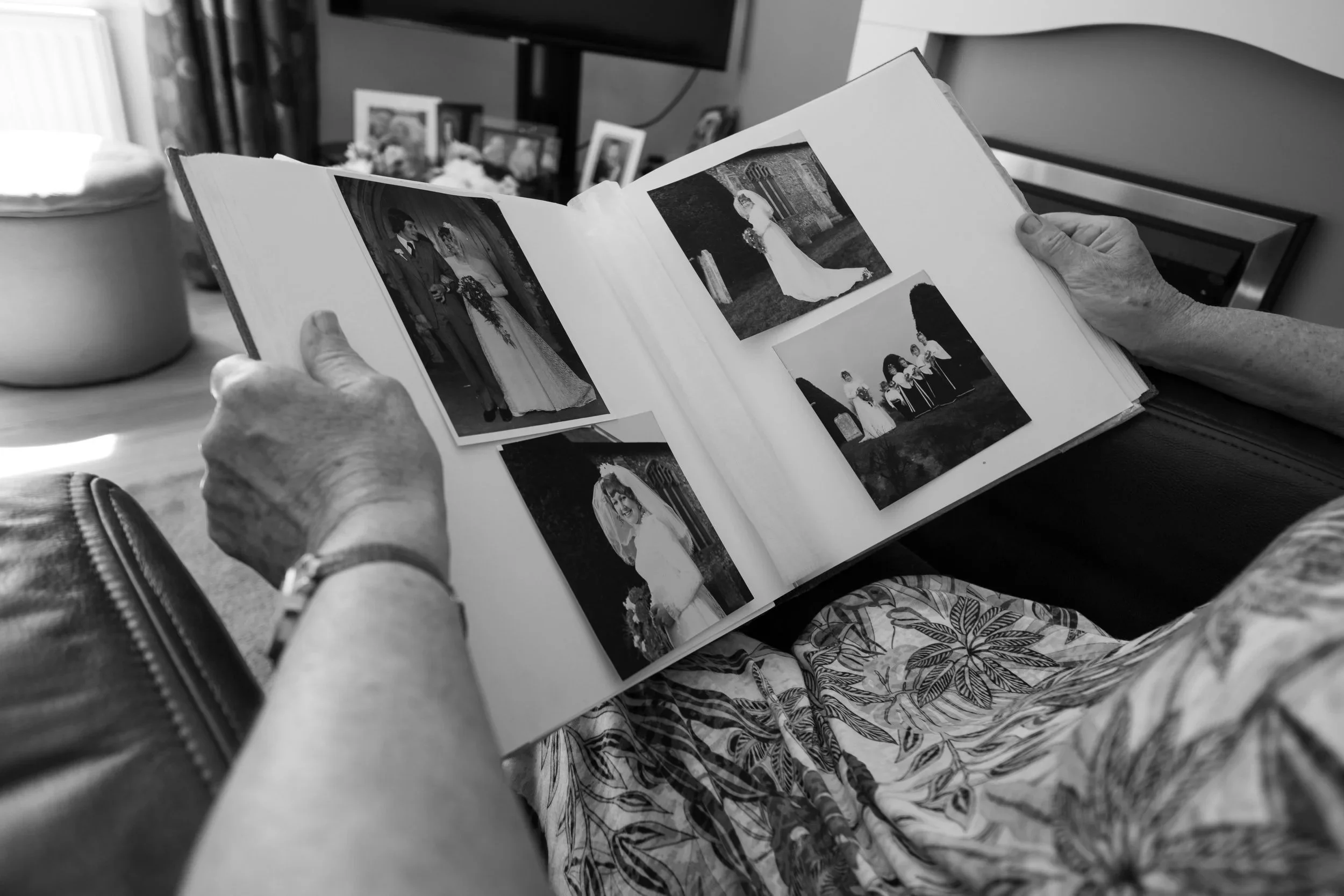 Women reflecting on different phases of womanhood over time as she looks at wedding photos