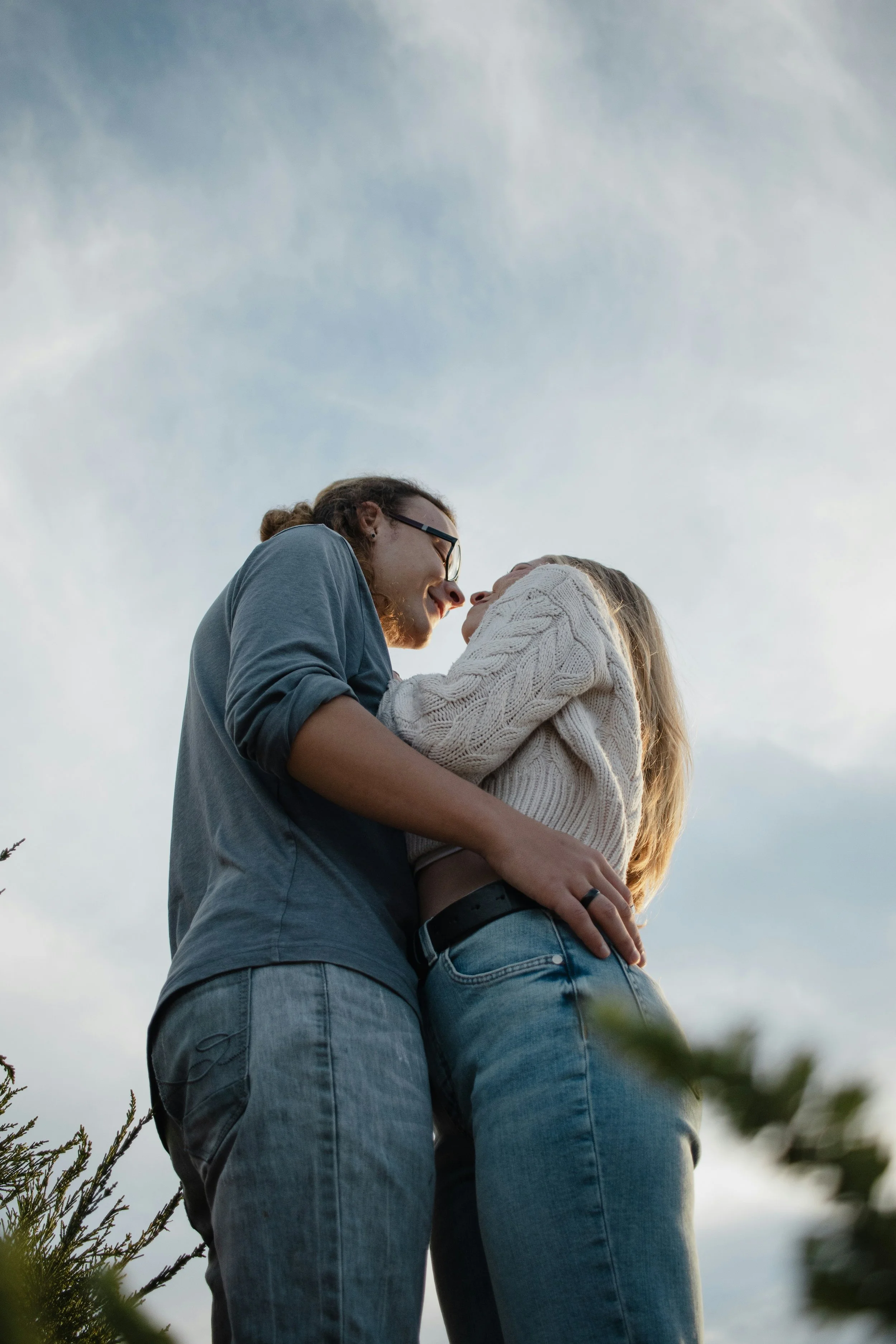 Engaged couple embracing outdoors, celebrating their commitment to each other