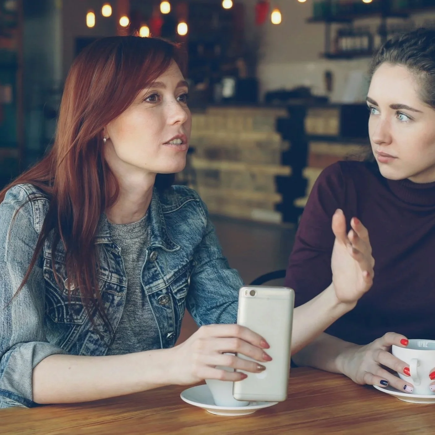 Two friends talking at coffee shop