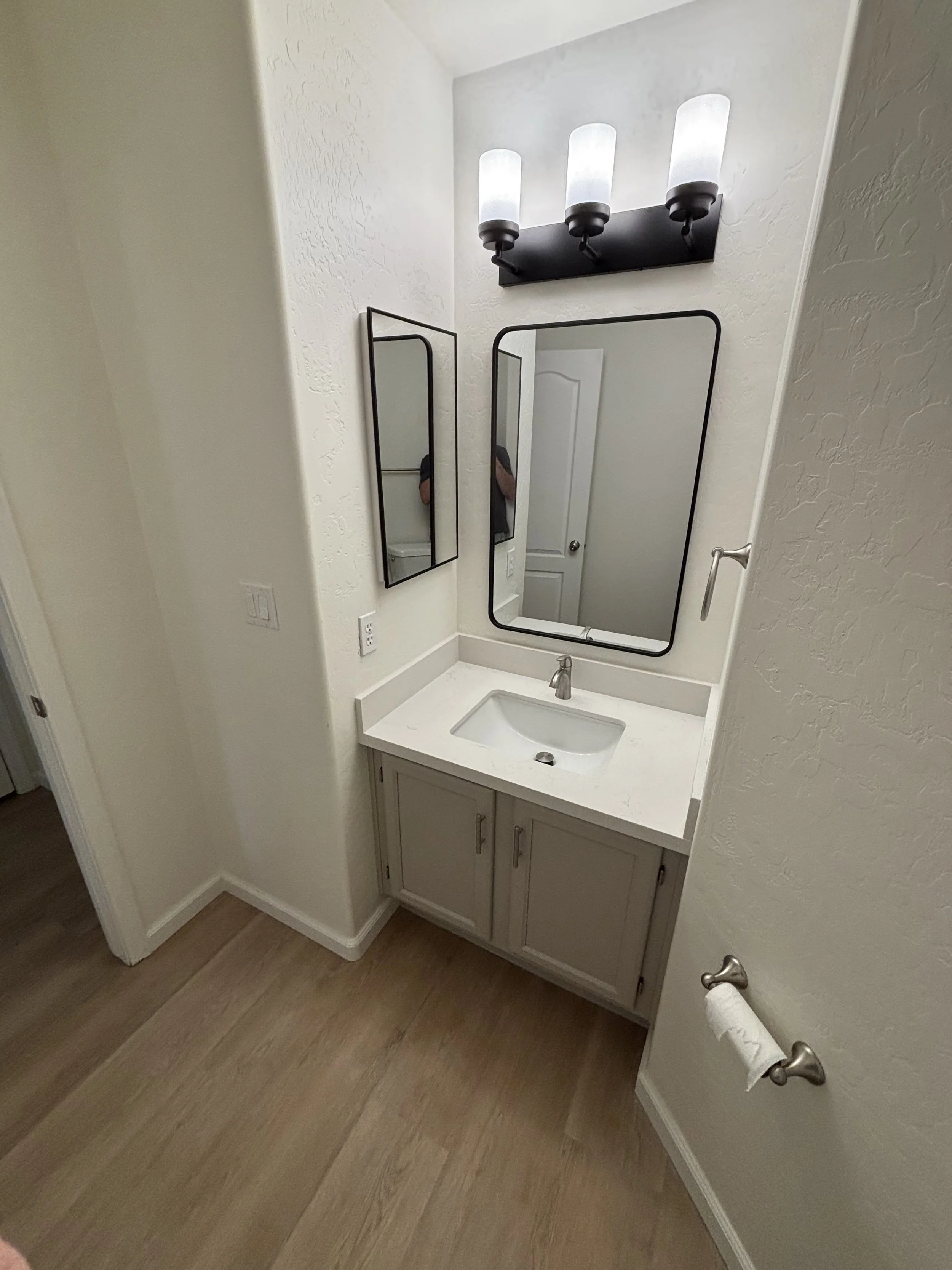 Powder Room Refresh with Refinished Cabinets, New Accessories & Fixtures