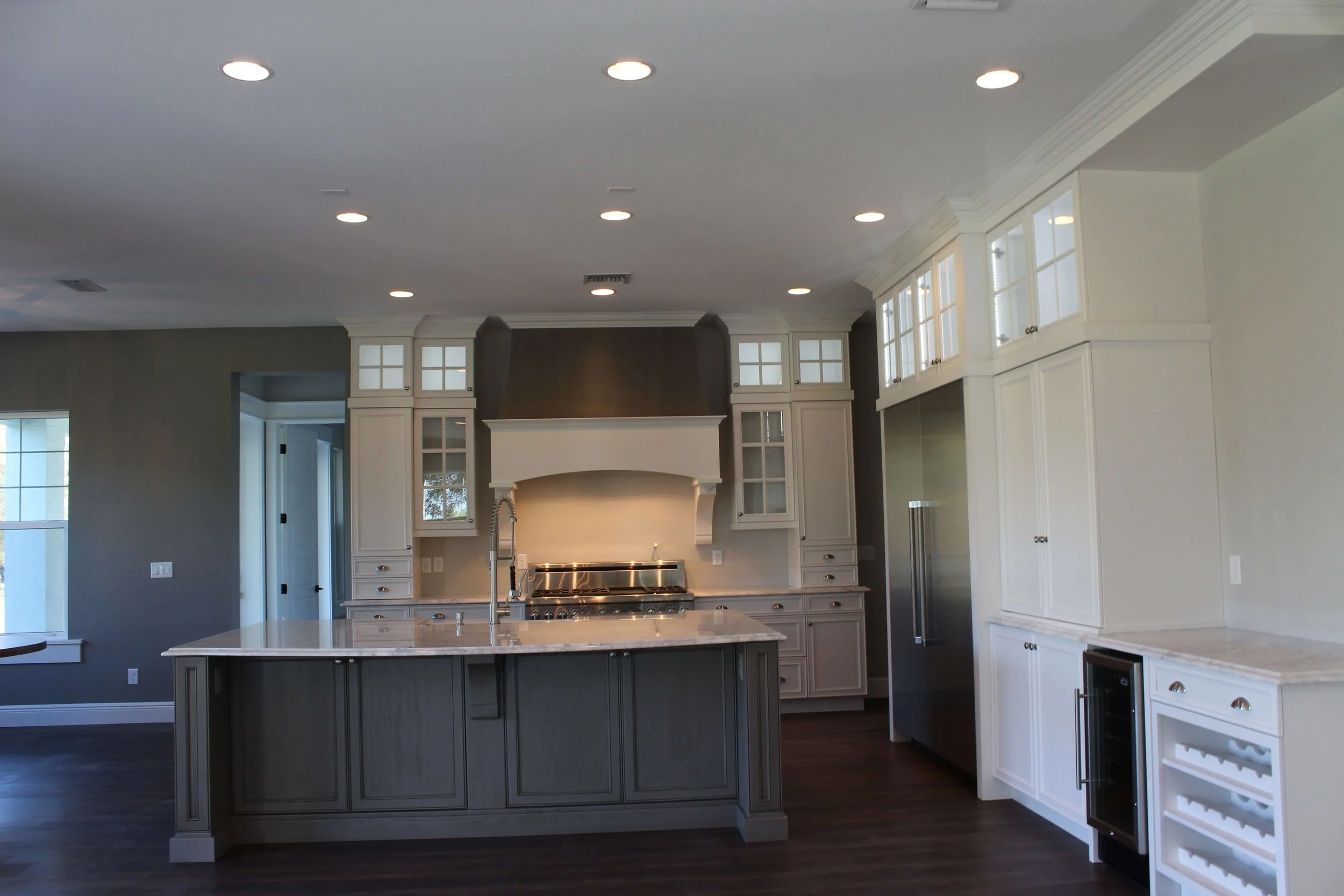 Image of a modern style kitchen in grays and whites and stainless steel appliances
