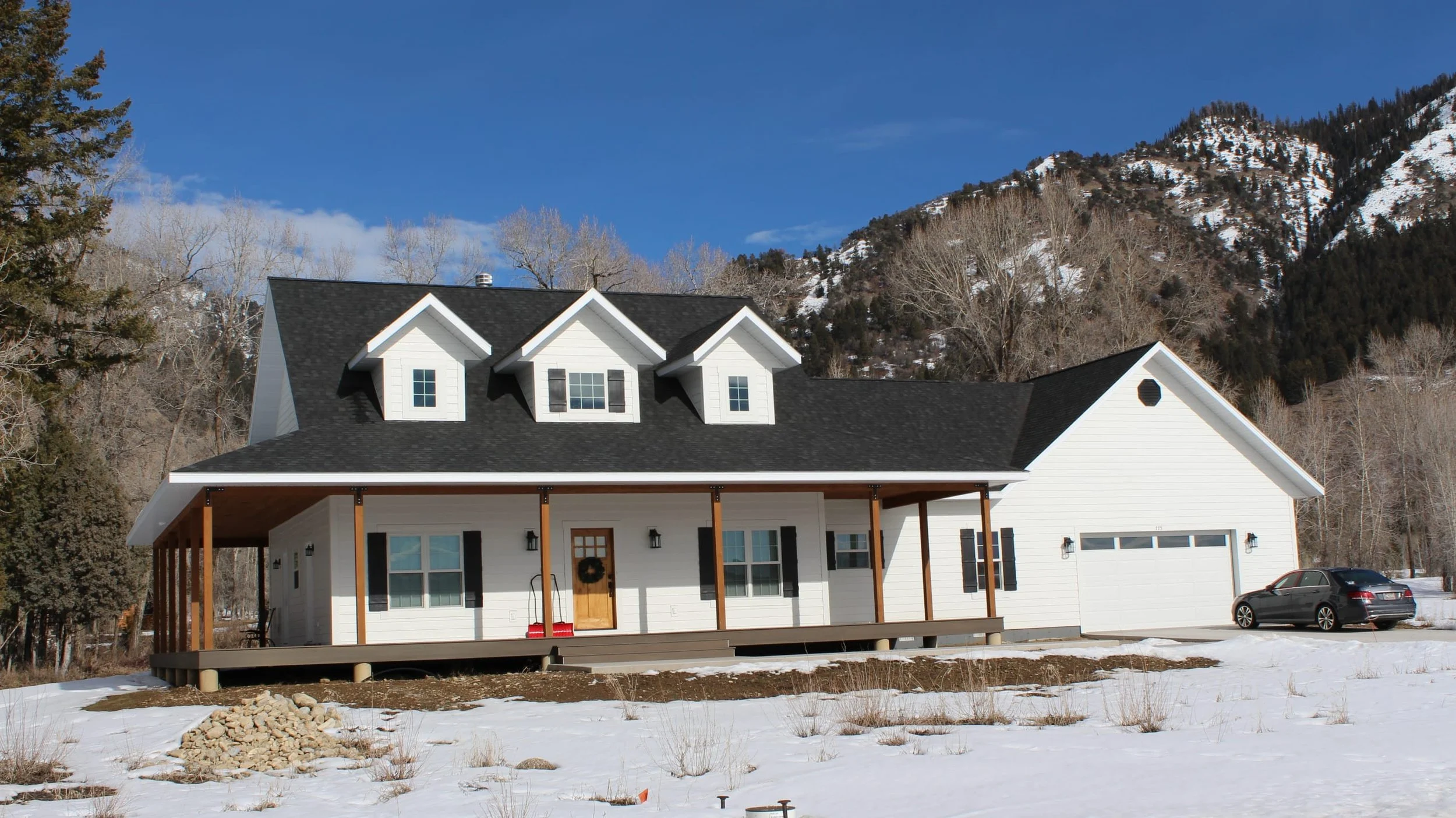 White sided home with 3 dormers located in Star Valley Ranch, Wyoming.