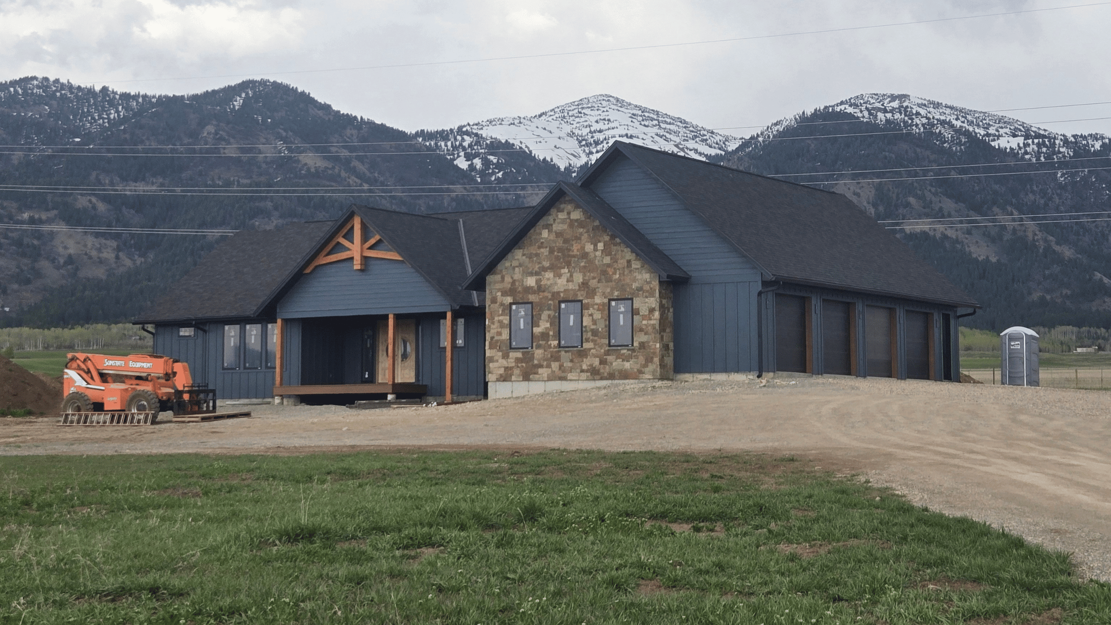 New home construction in star valley WY witha backdrop of the mountains with snow on them.