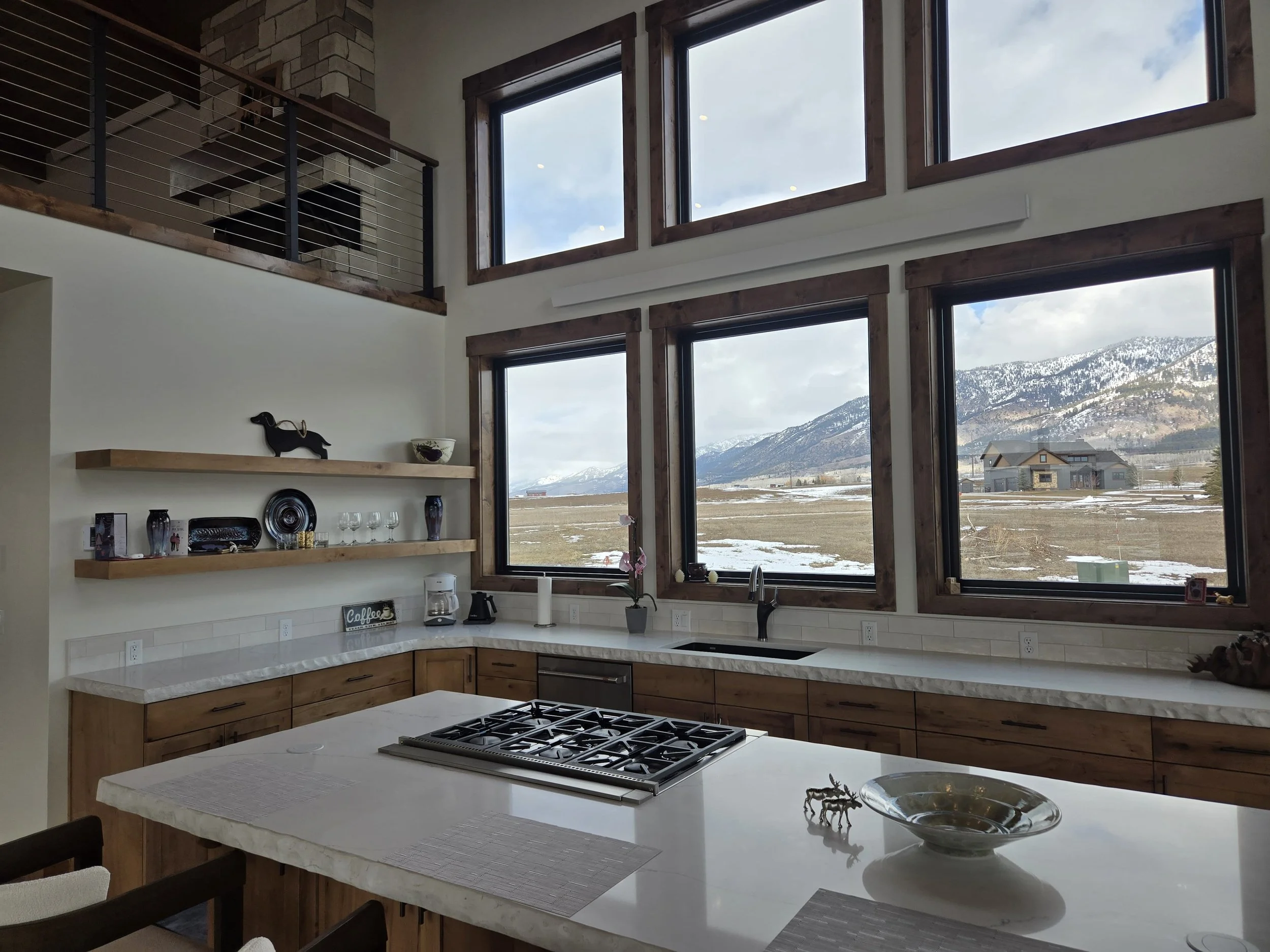 Open kitchen with lots of natural light from large windows in a house located in Thayne, Wyoming