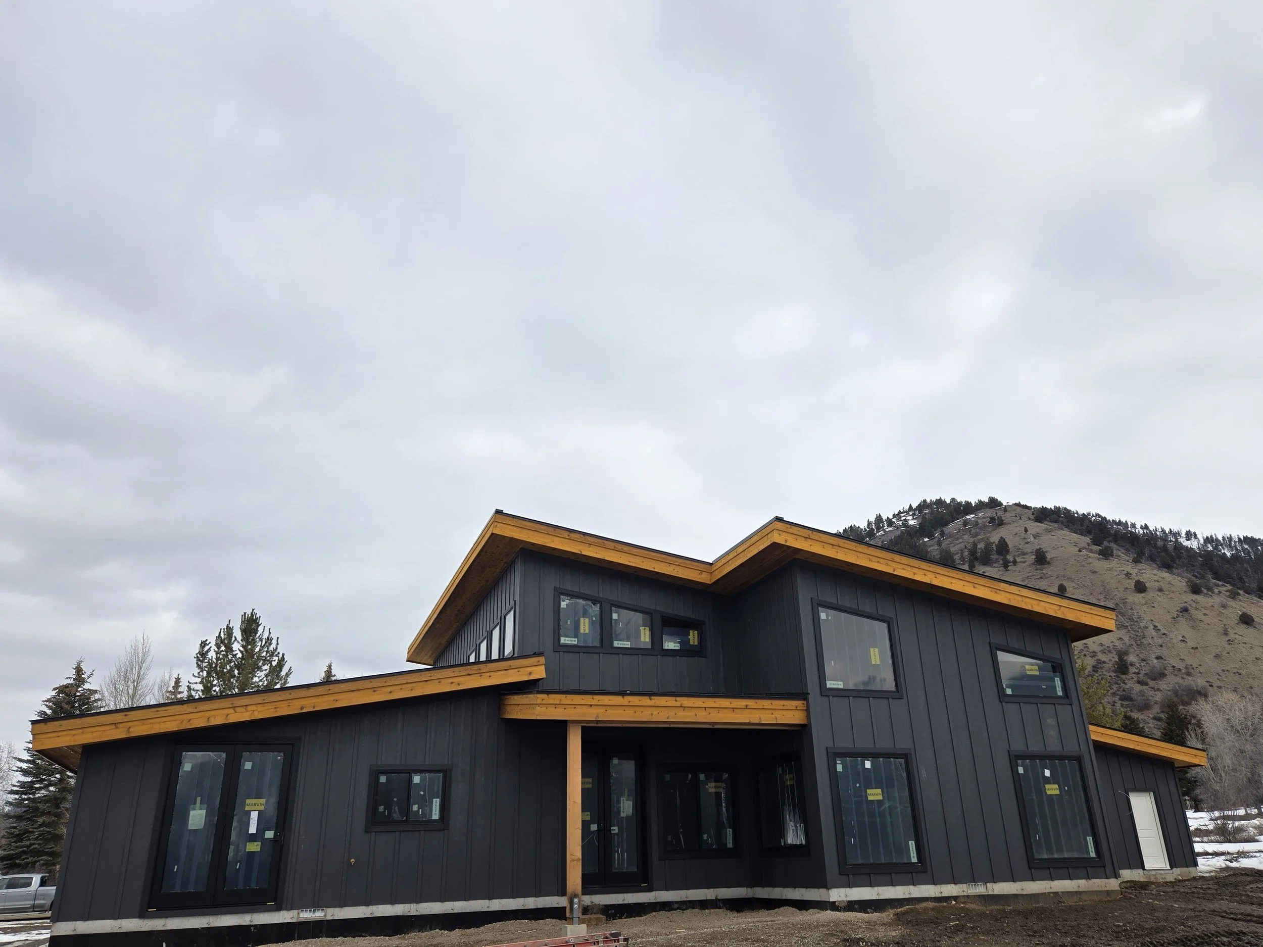 Modern style home with black siding and timber accents. Located in Star Valley Ranch, Wyoming