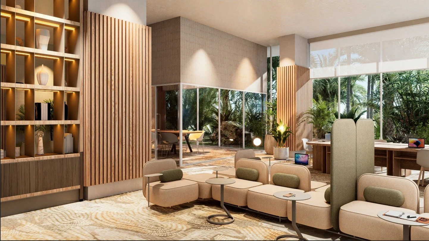 Modern lounge area with beige couches, small tables, and potted plants, large windows showing outdoor greenery.