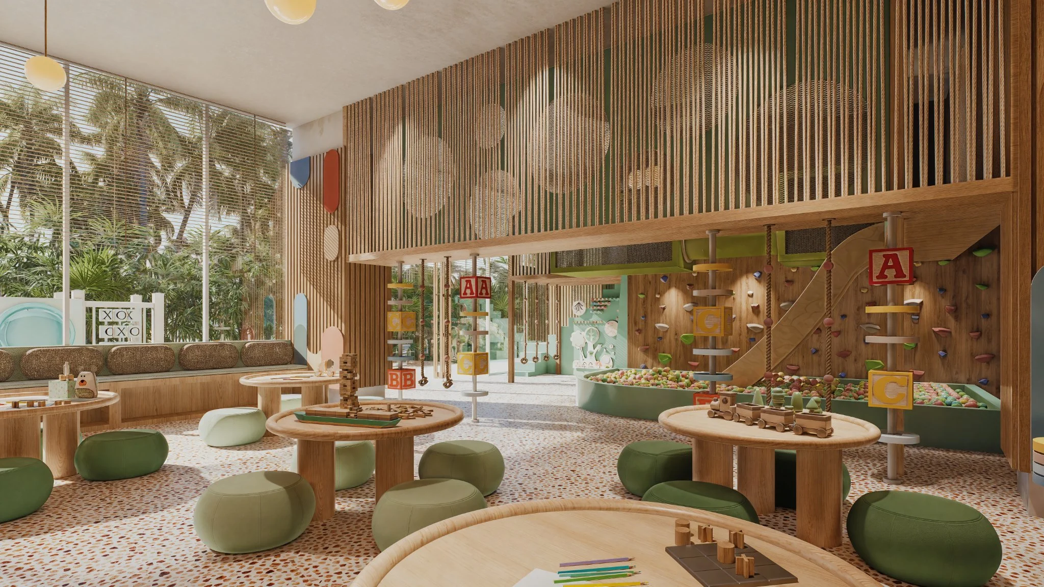 Colorful indoor children’s play area with wooden furniture, a climbing wall, ball pit, and large windows showing palm trees outside.